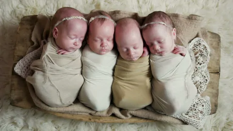 Quadruplet babies in a cradle | Photo: Getty Images