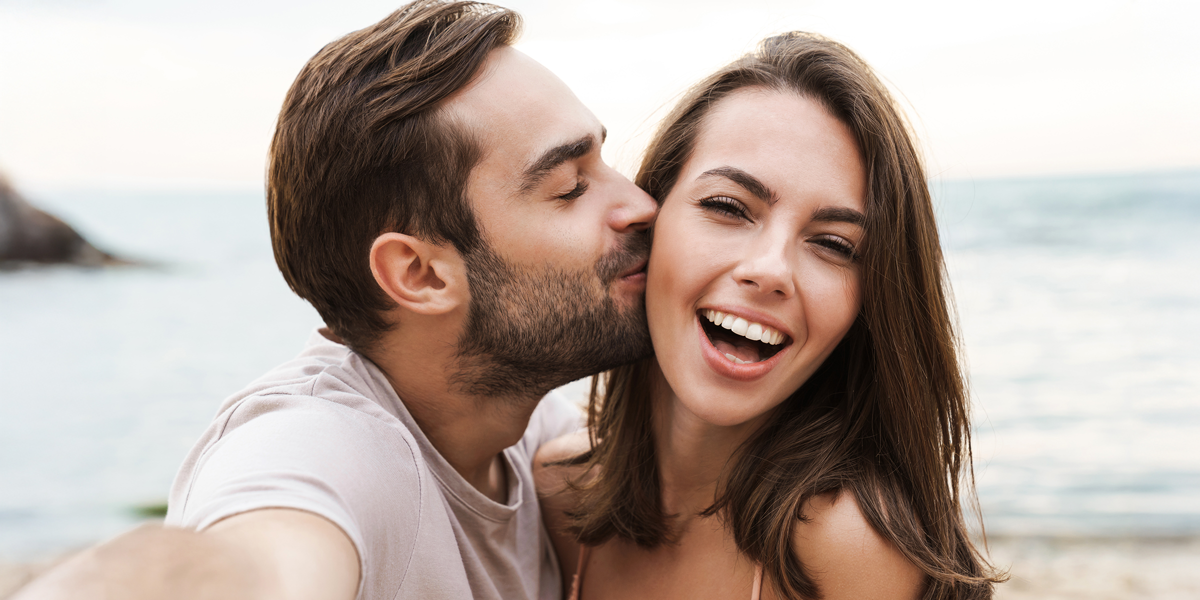 A smiling young couple | Source: Shutterstock