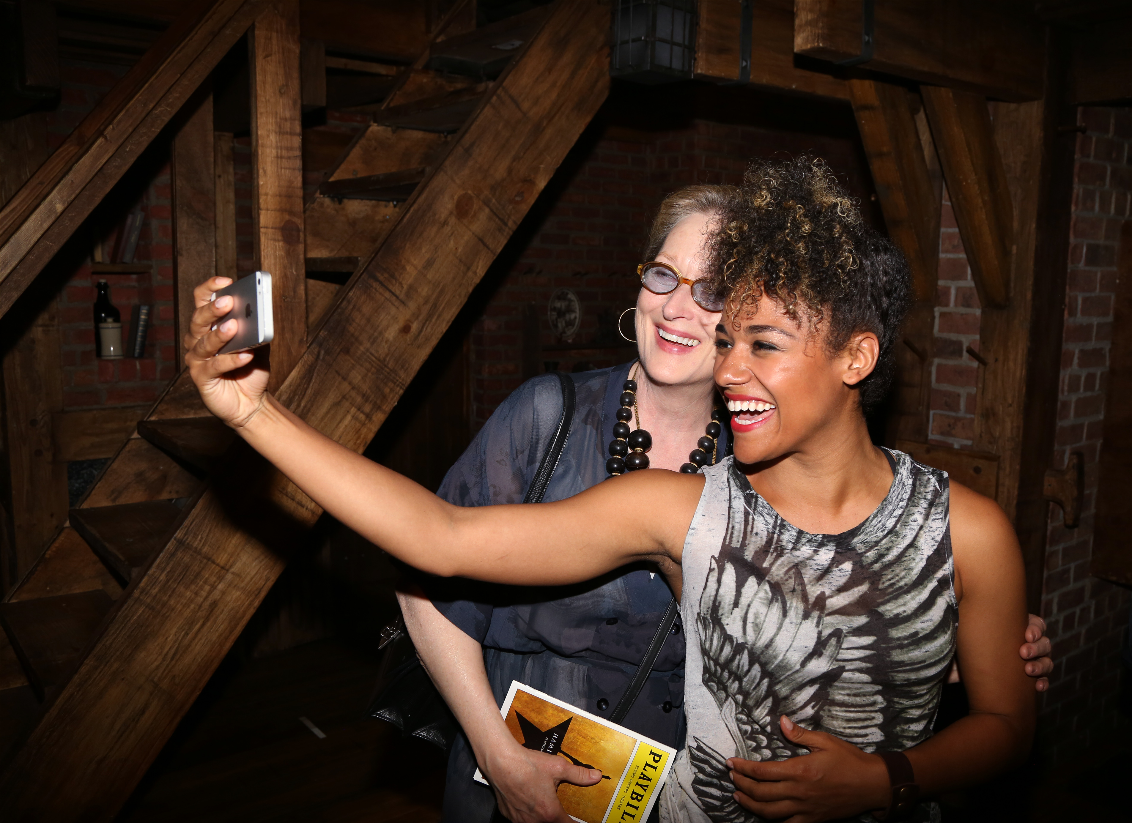 Meryl Streep visits Emmy Raver-Lampman from the cast of "Hamilton" backstage after a performance at the Richard Rodgers Theatre, on August 13, 2015 in New York City. | Source: Getty Images