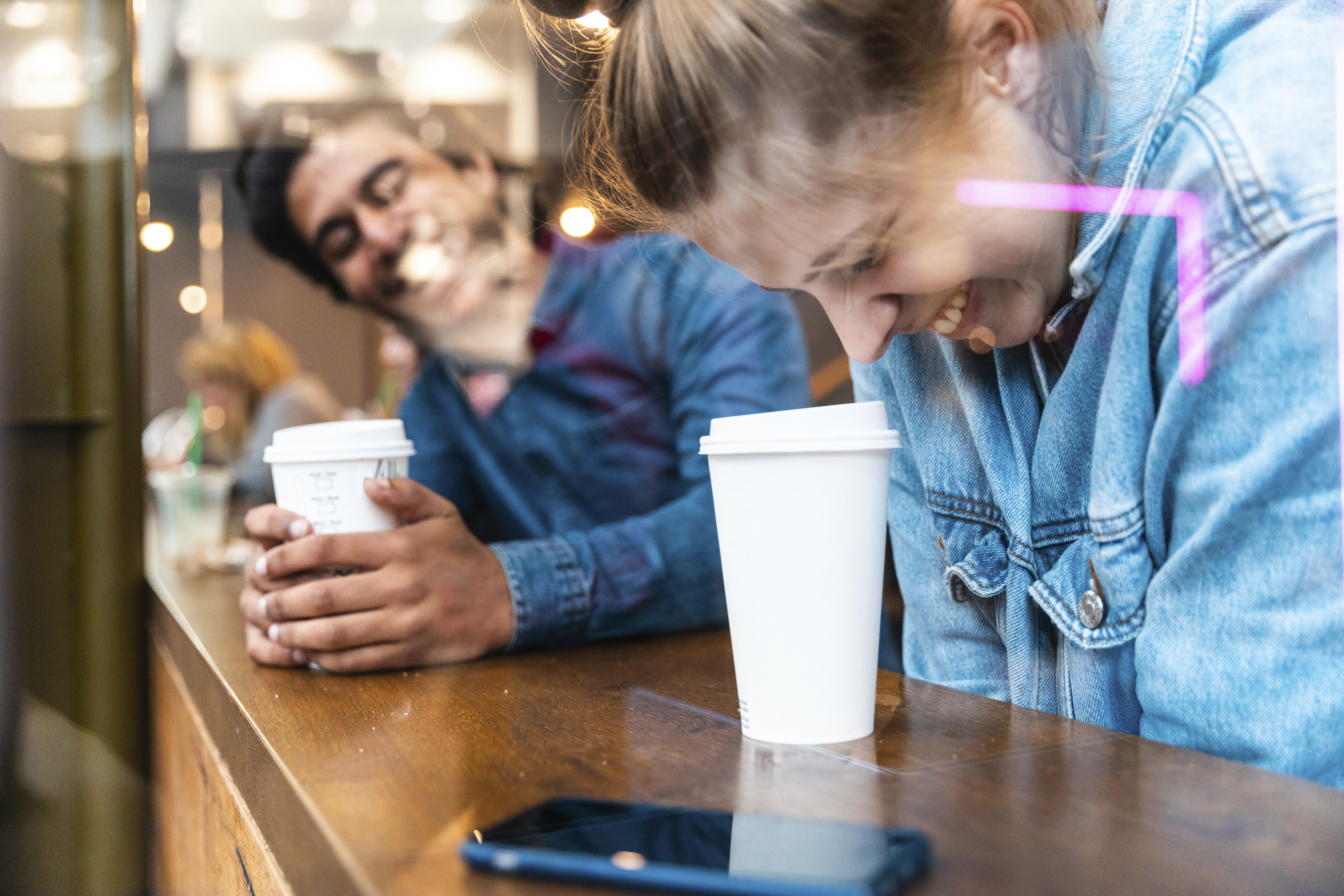 Friends having fun together in a coffee shop | Source: Getty Images