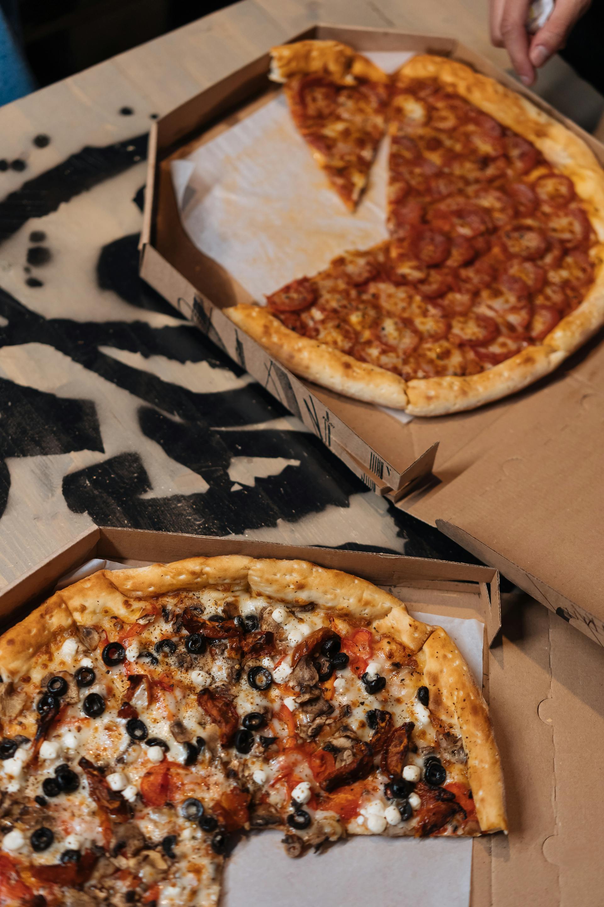 Boxes of pizza on a table | Source: Pexels
