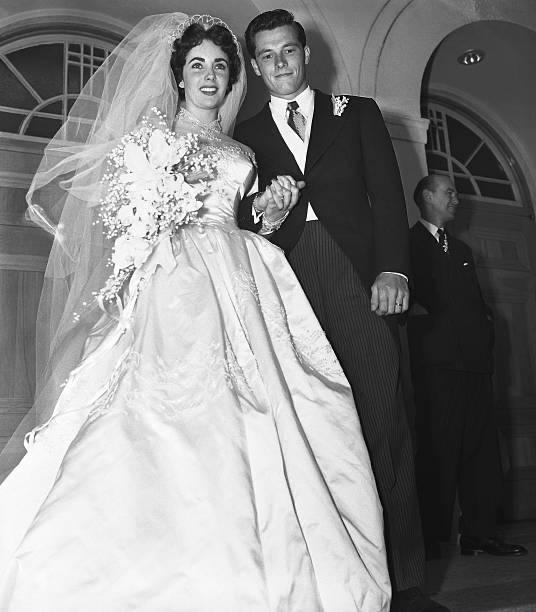 Mr. and Mrs. Conrad Hilton Jr. on the steps of the Church of the Good Shepherd after their wedding. | Photo: Getty Images