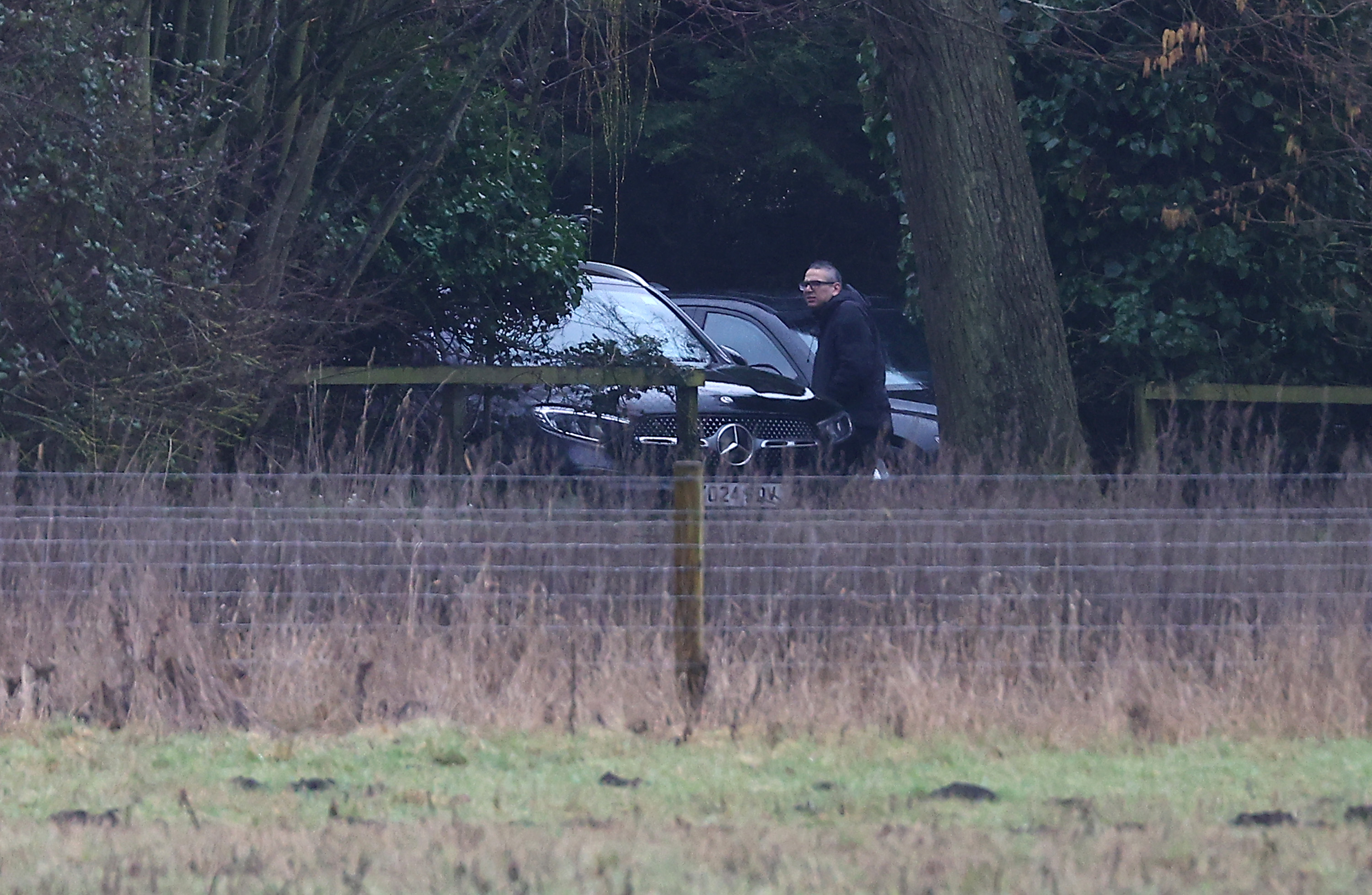 A man steps out of an unmarked car at the home of Andrew Mountbatten-Windsor on February 19, 2026 in Sandringham, Norfolk | Source: Getty Images