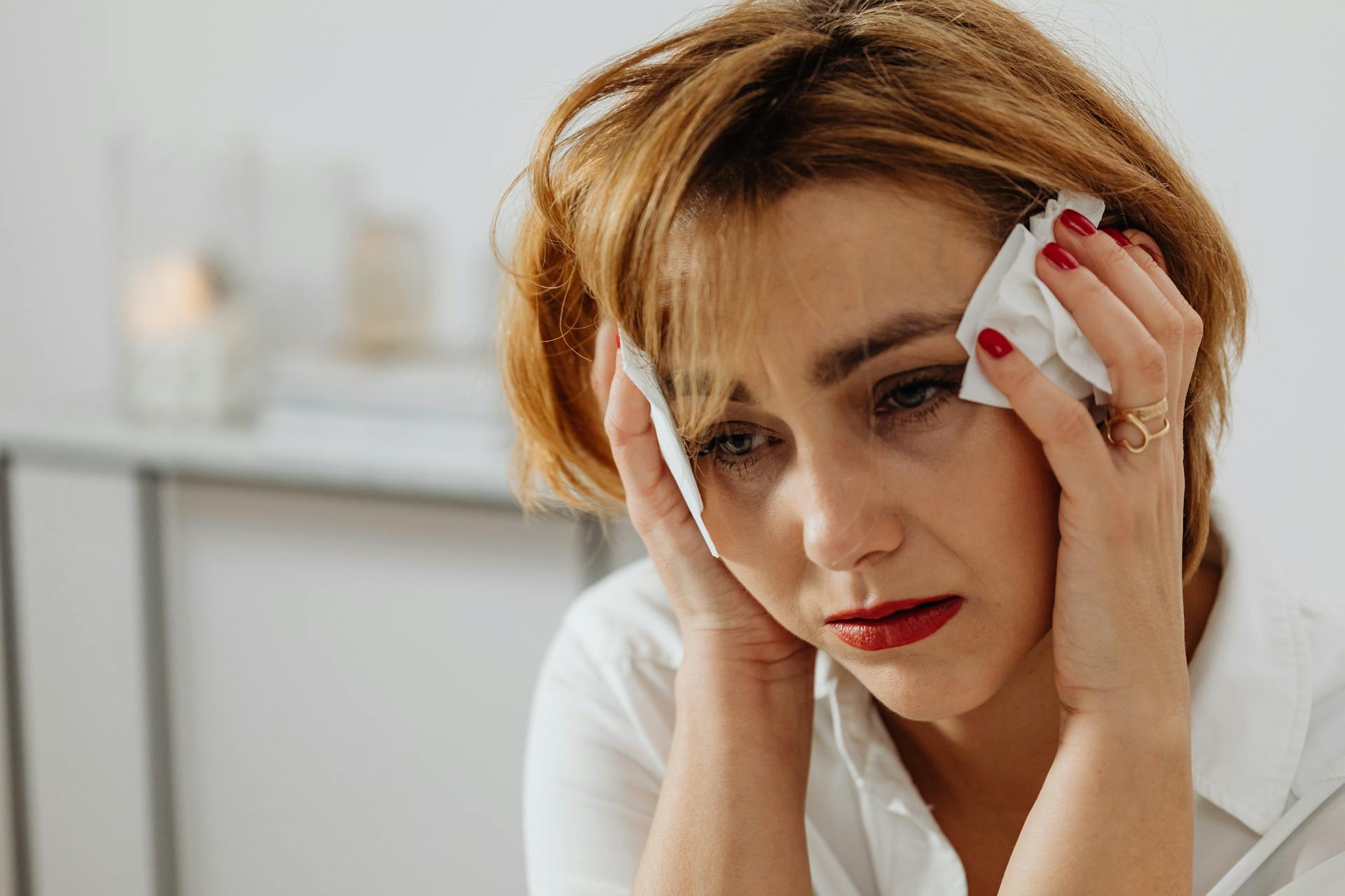 Distressed woman holding tissue paper | Source: Pexels