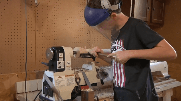 Tommy Rhomberg making a bat to raise money for his community | Photo: YouTube/CBS Evening News