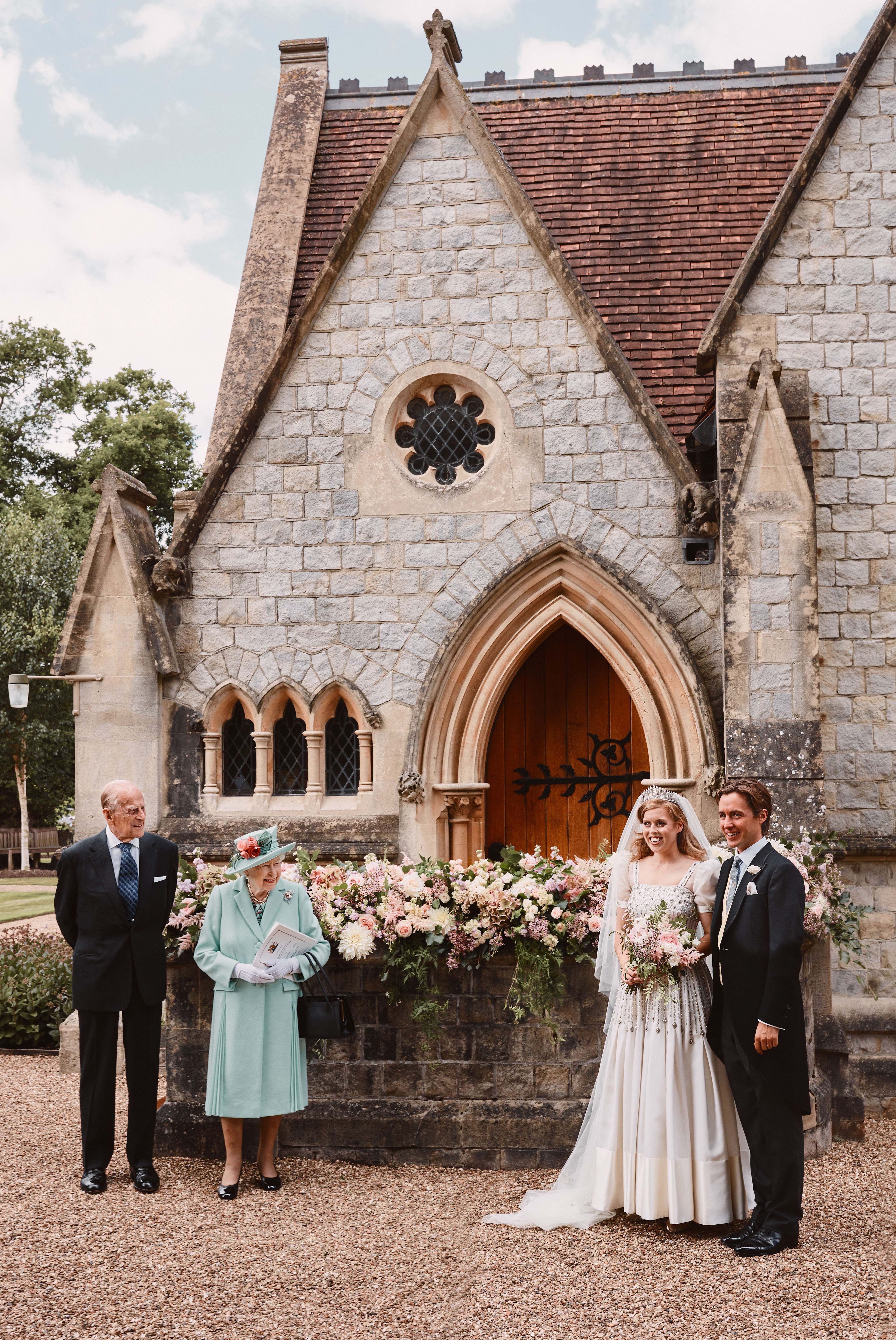 Princess Beatrice and Edoardo Mapelli Mozzi stands outside The Royal Chapel of All Saints at Royal Lodge, Windsor, after their wedding, with Queen Elizabeth II and Prince Philip, Duke of Edinburgh, on July 18, 2020, in England. | Source: Getty Images