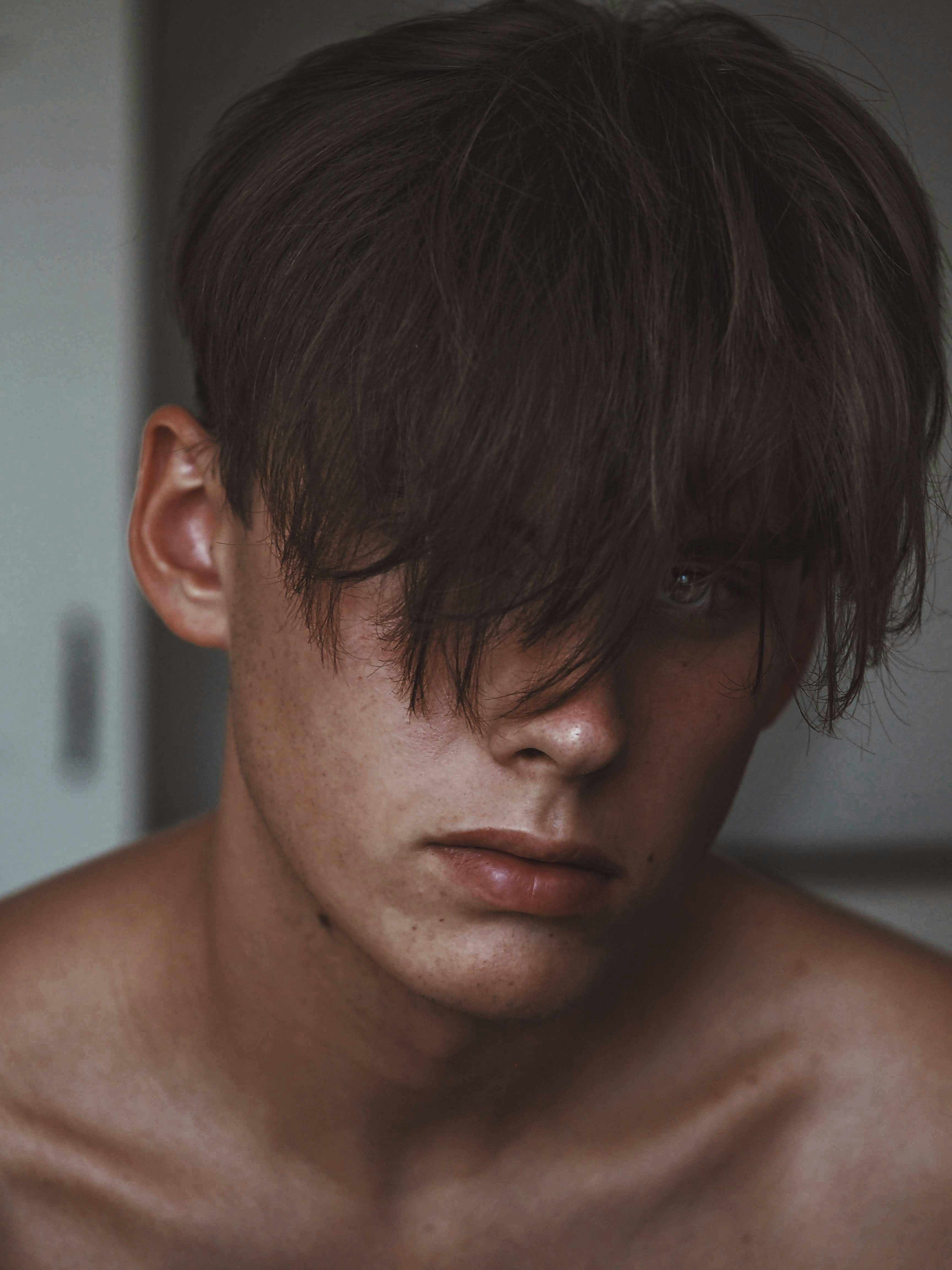 A sad shirtless man | Source: Unsplash