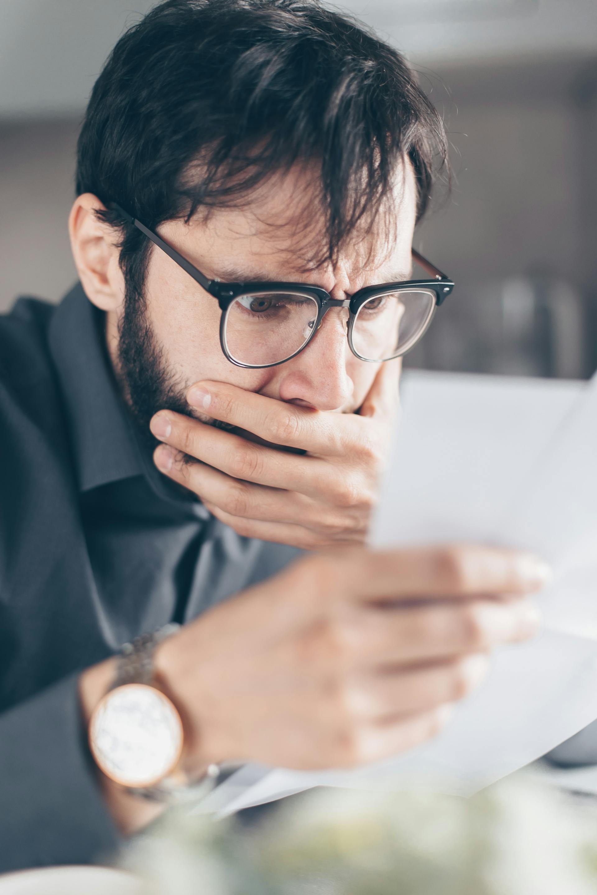 A shocked man reading a piece of paper | Source: Pexels