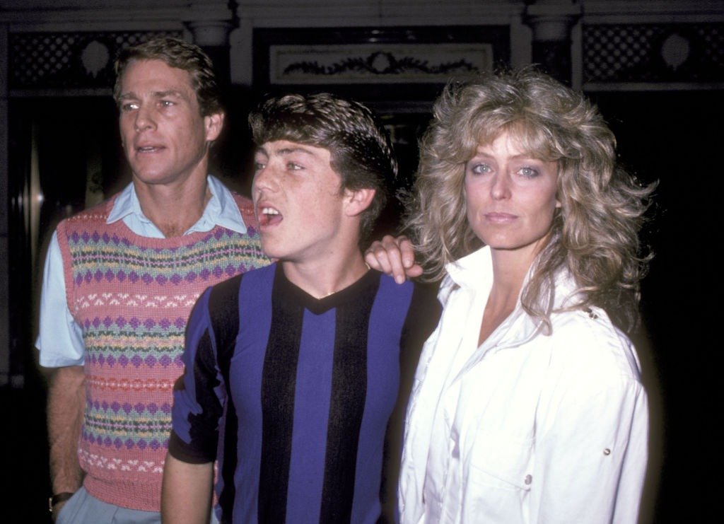 Ryan O'Neal, his son Griffin O'Neal and Farrah Fawcett attends a performance of "Nine" at 42nd Street Theatre on June 16, 1982. | Photo: Getty Images