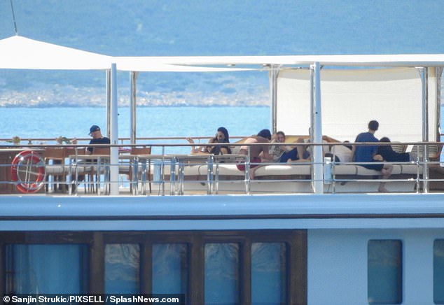 Other guests opted to relax on the top level of the yacht, basking in the sunlight