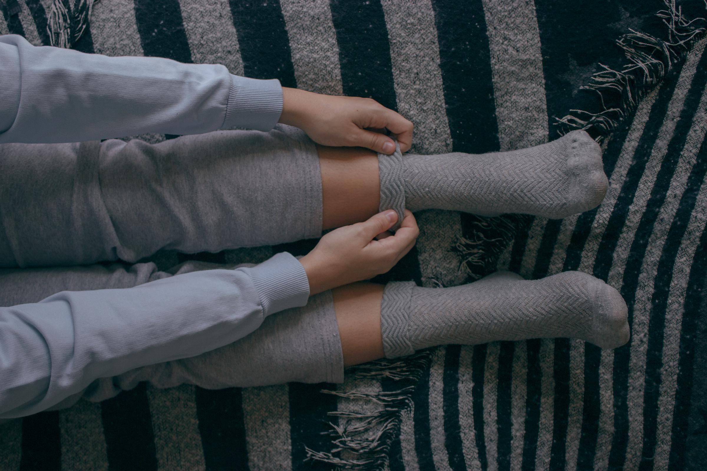 A girl pulling on some socks | Source: Getty Images