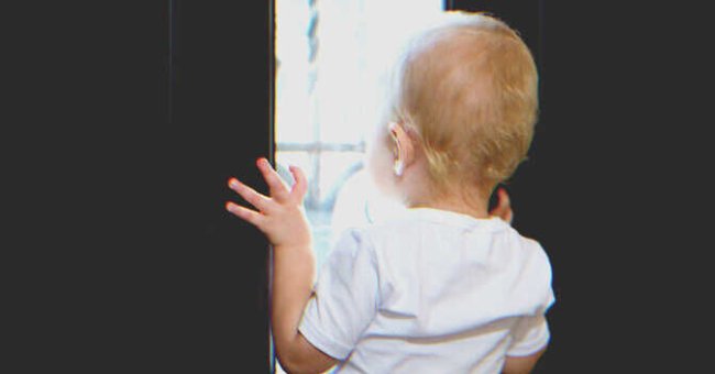 The little boy was peeping through the window and crying for help. | Source: Shutterstock