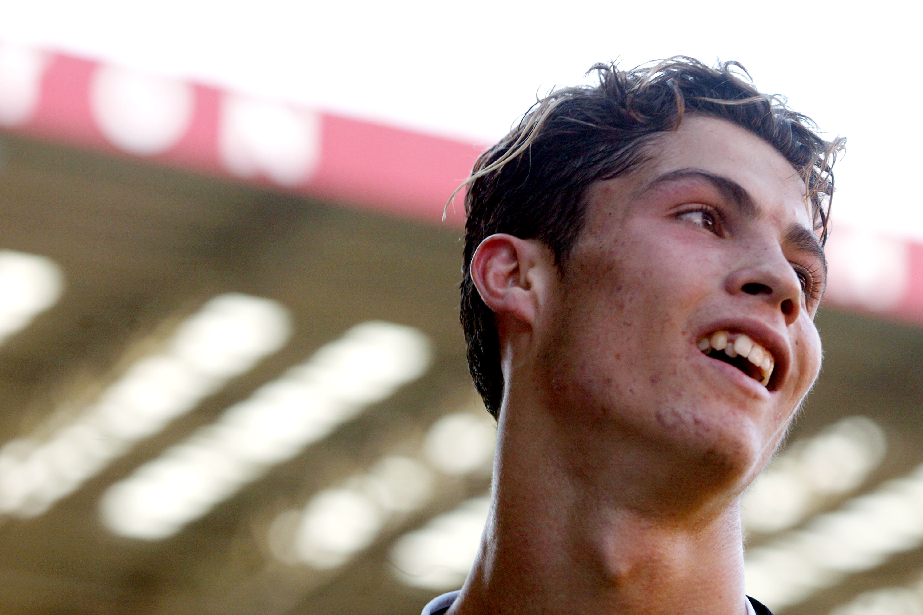 Cristiano Ronaldo looked on during Manchester United's Premier League match against Charlton Athletic on September 13, 2003. Captured early in his professional career, the then-18-year-old forward sported a youthful appearance, complete with braces and natural facial features, years before becoming one of soccer's most recognizable stars.