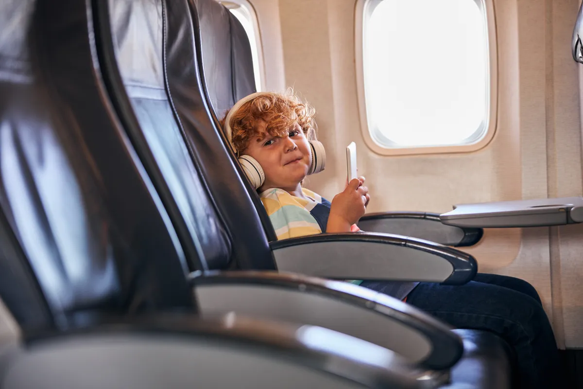 A mischievous child on a plane | Source: Shutterstock