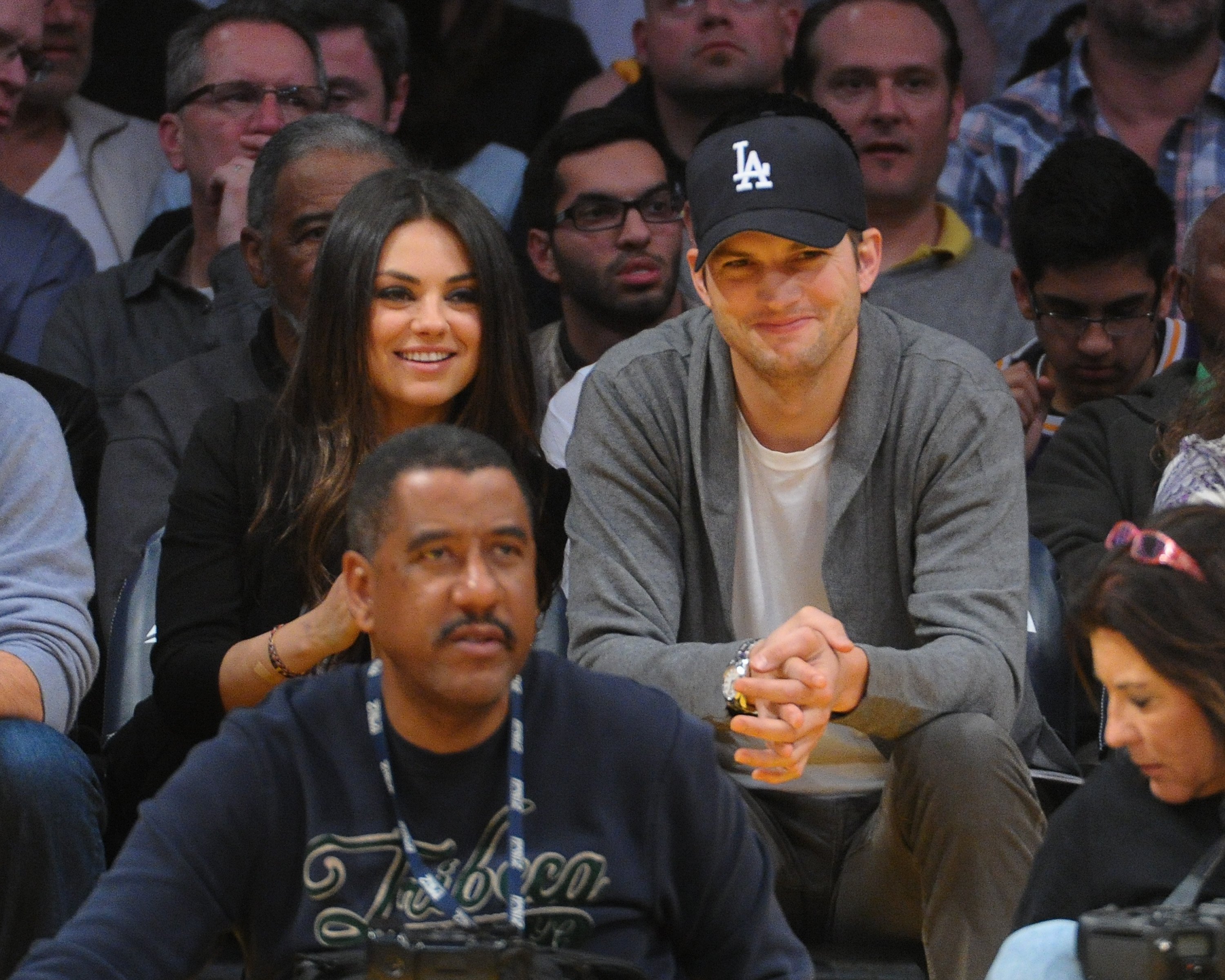  Mila Kunis (L) and Ashton Kutcher attend a basketball game between the Phoenix Suns and the Los Angeles Lakers at Staples Center on February 12, 2013 | Source: Getty  Images 