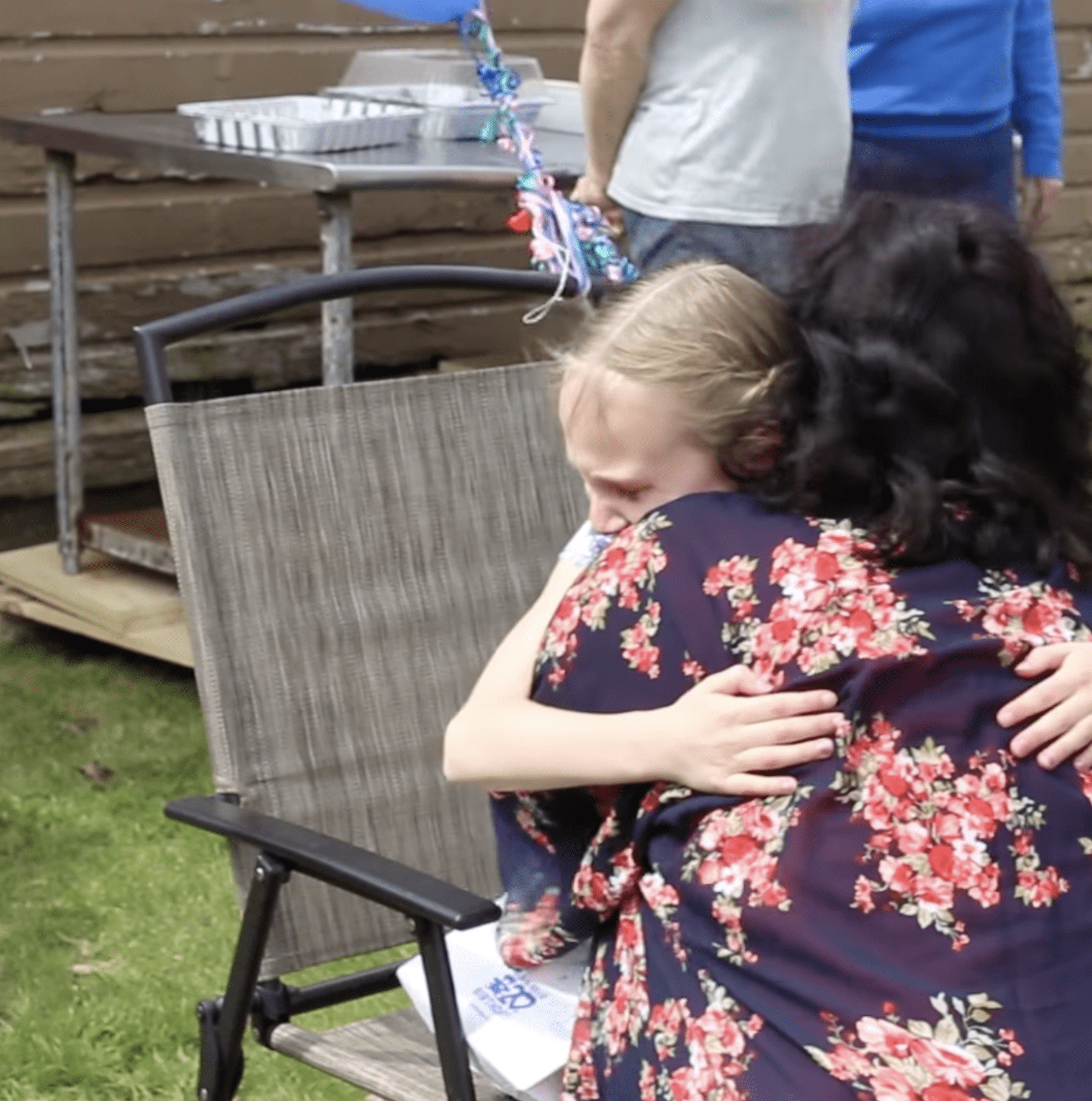 Haley sharing an emotional hug with her stepmom, Brigitte. | Photo: YouTube.com/PokeMyHeart
