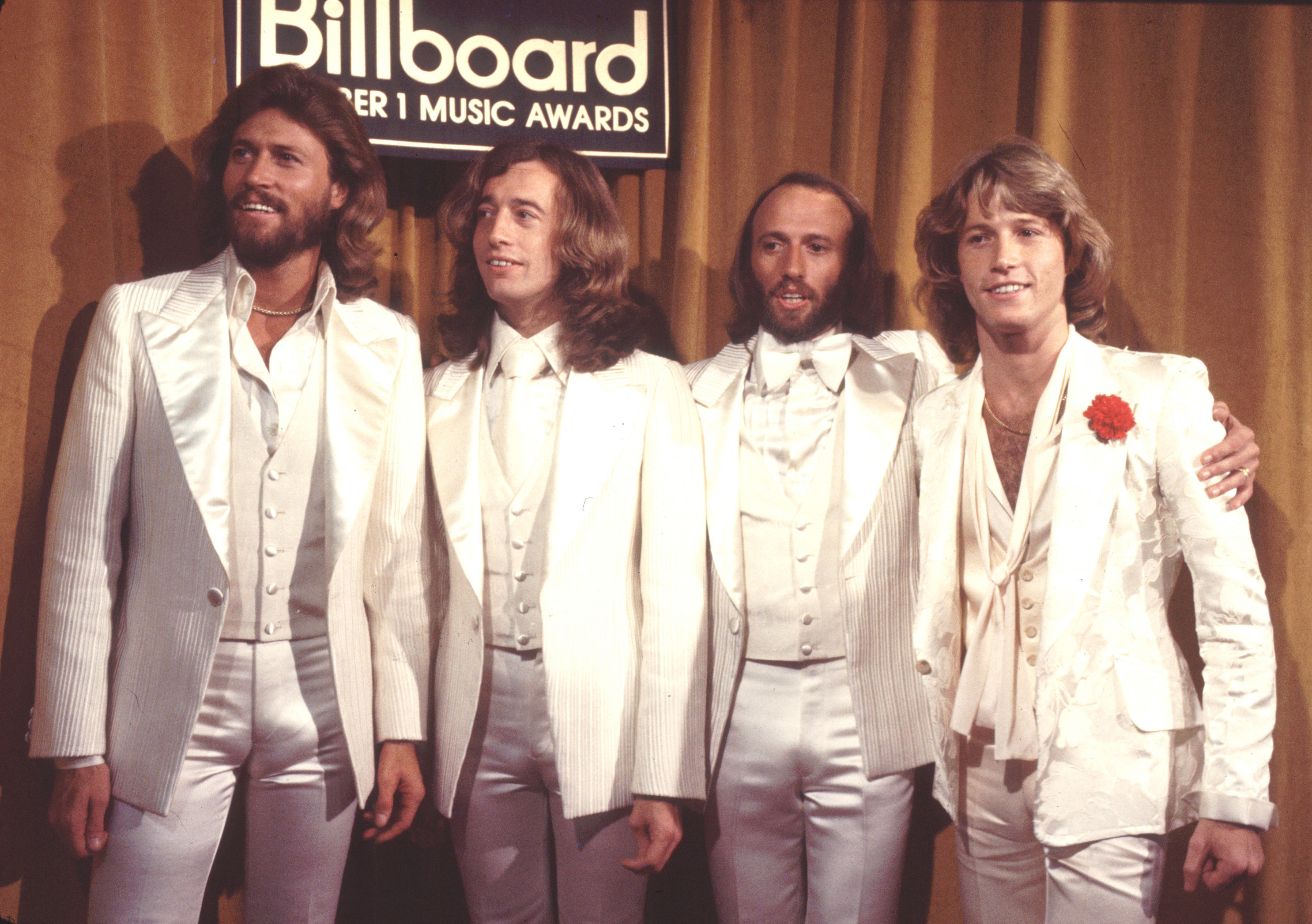 Barry Gibb, Robin Gibb, Maurice Gibb, and Andy Gibb at the Billboard Music Awards in 1977 | Source: Getty Images
