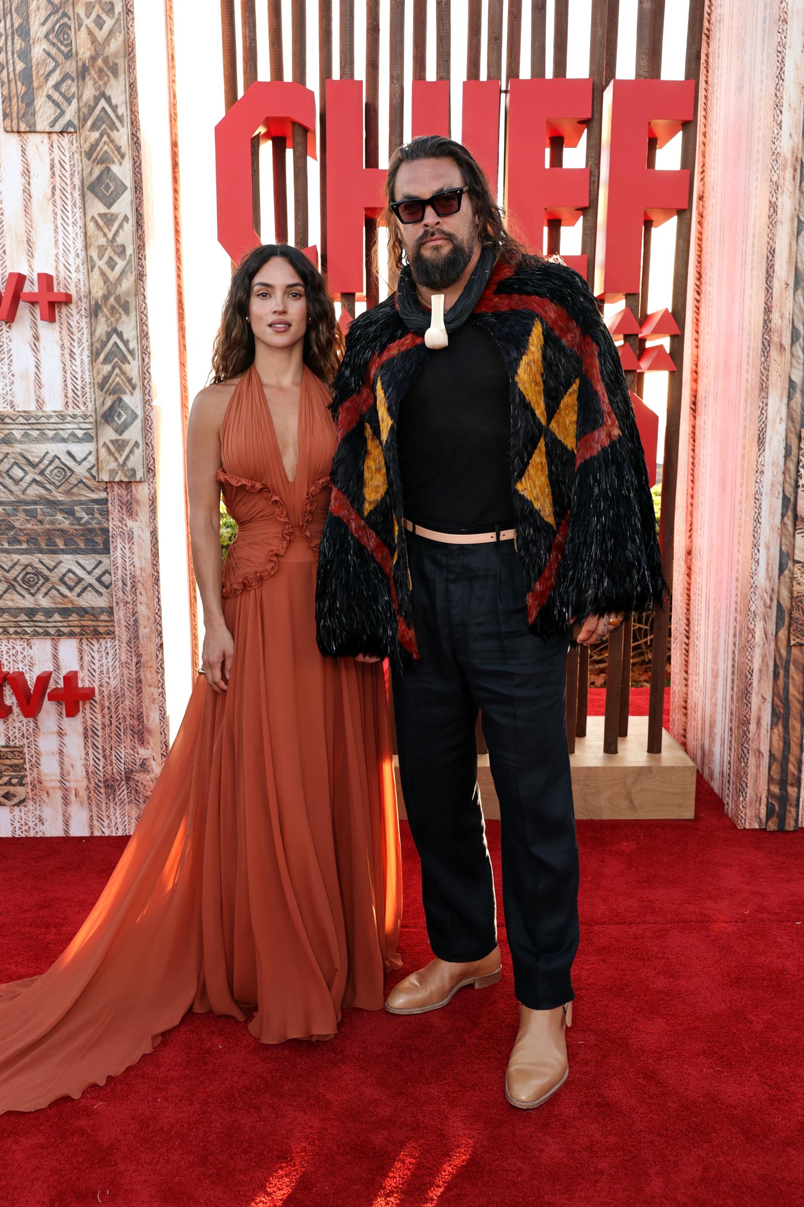 Adria Arjona and Jason Momoa are seen at the world premiere of the Apple TV+ series “Chief of War” at the Ko Olina Beach Park on July 18, 2025, in Kapolei, Hawaii. | Source: Getty Images