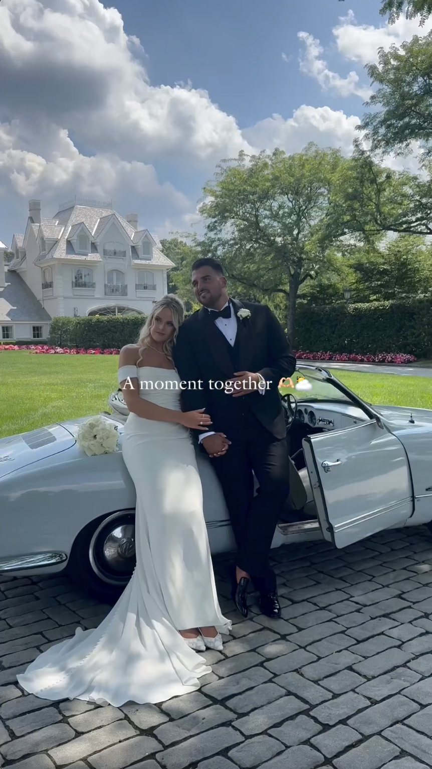 Victoria Schultz and Jon Runyan Jr. posing by a vintage car on their wedding day, posted on July 10, 2024 | Source: Instagram/antpagephoto, alenkafilms and victoriajrunyan