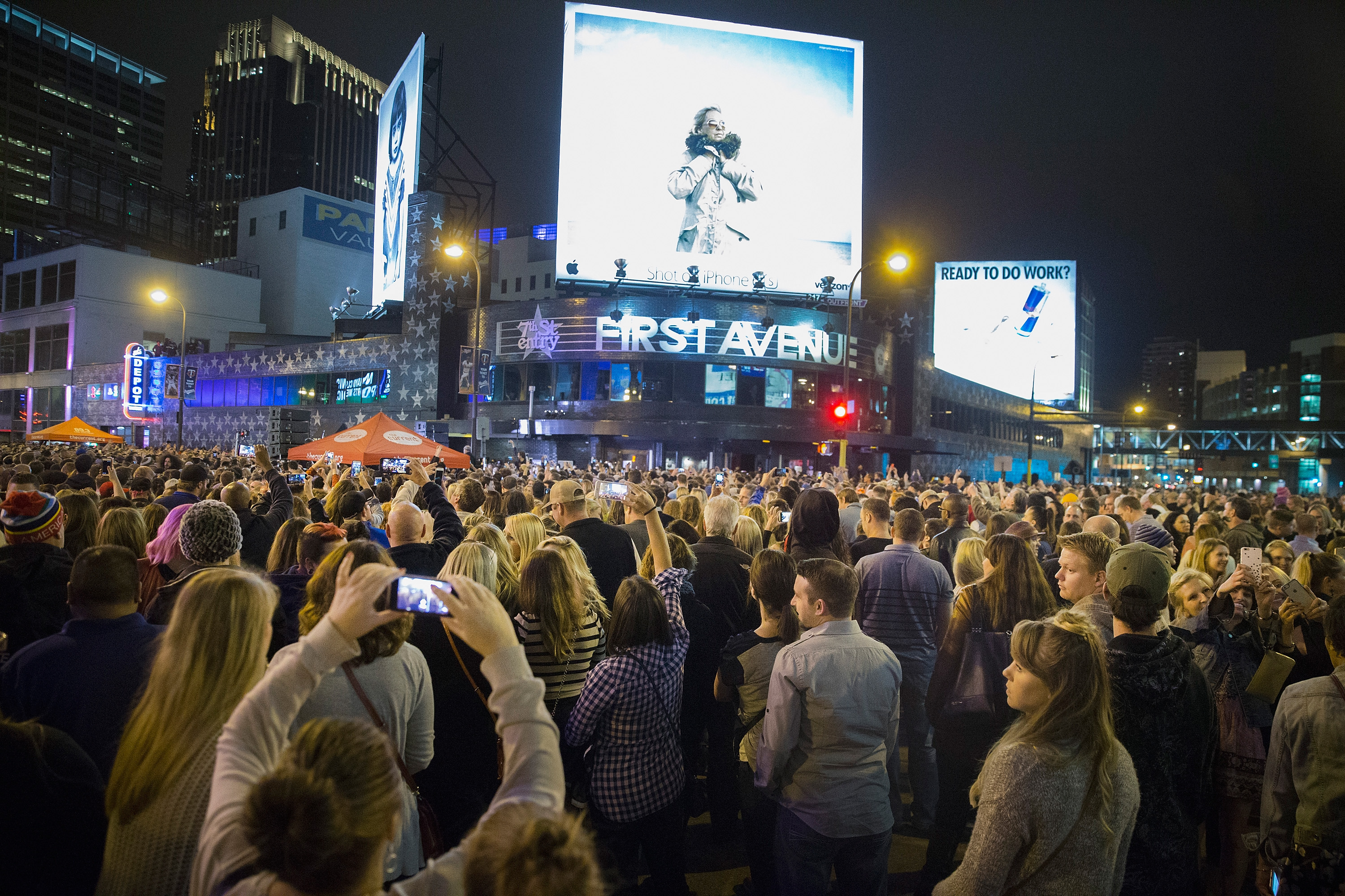 Fans gather to listen to Prince's music during a memorial street party outside the First Avenue nightclub in Minneapolis, Minnesota on April 21, 2016 | Source: Getty Images