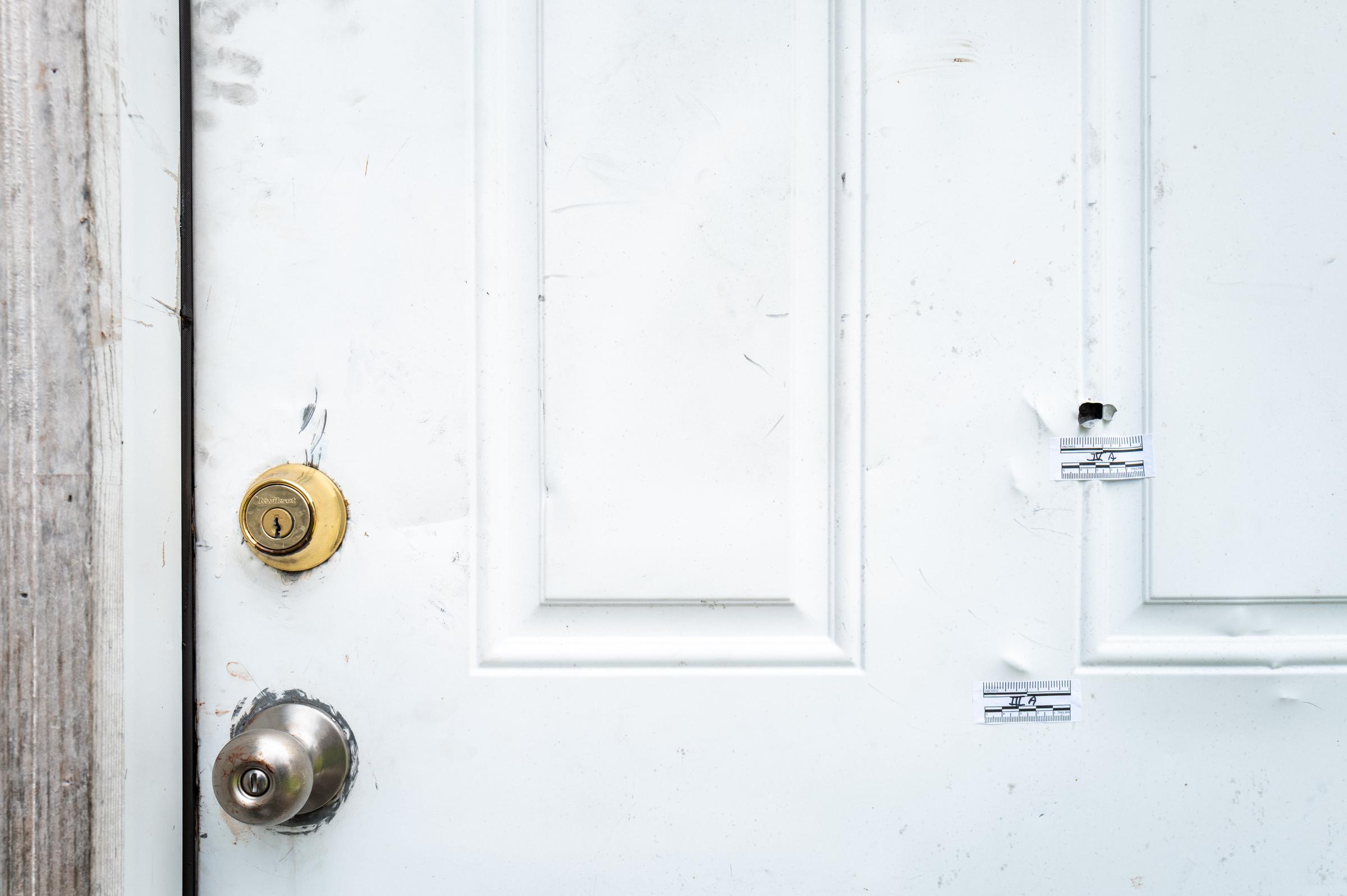 Bullet holes are visible in the door of a home following the deadly shooting in Shreveport, Louisiana | Source: Getty Images