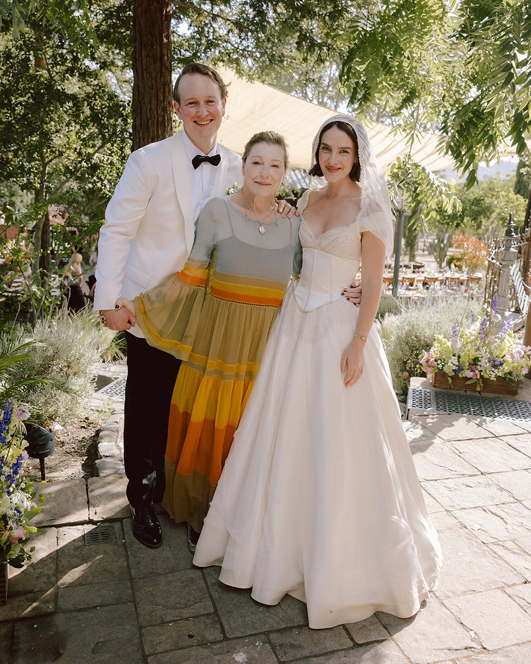 Tatum O'Neal posing with Kevin McEnroe and Fern Cozine at their wedding, from a post dated July 20, 2025 | Source: Instagram/tatum__oneal