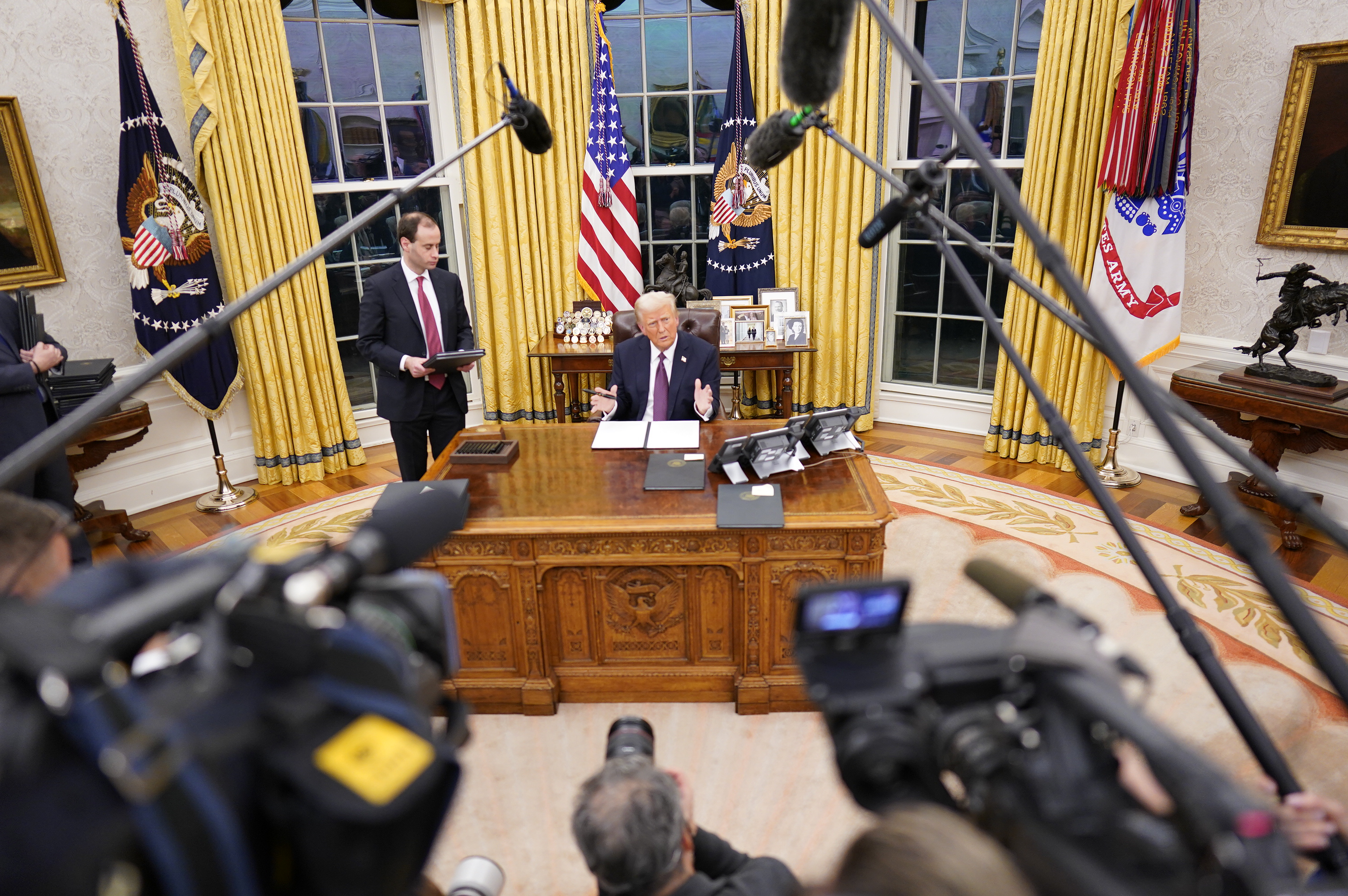 President Donald Trump signs a series of executive orders at the White House on January 20, 2025, in Washington, DC. | Source: Getty Images