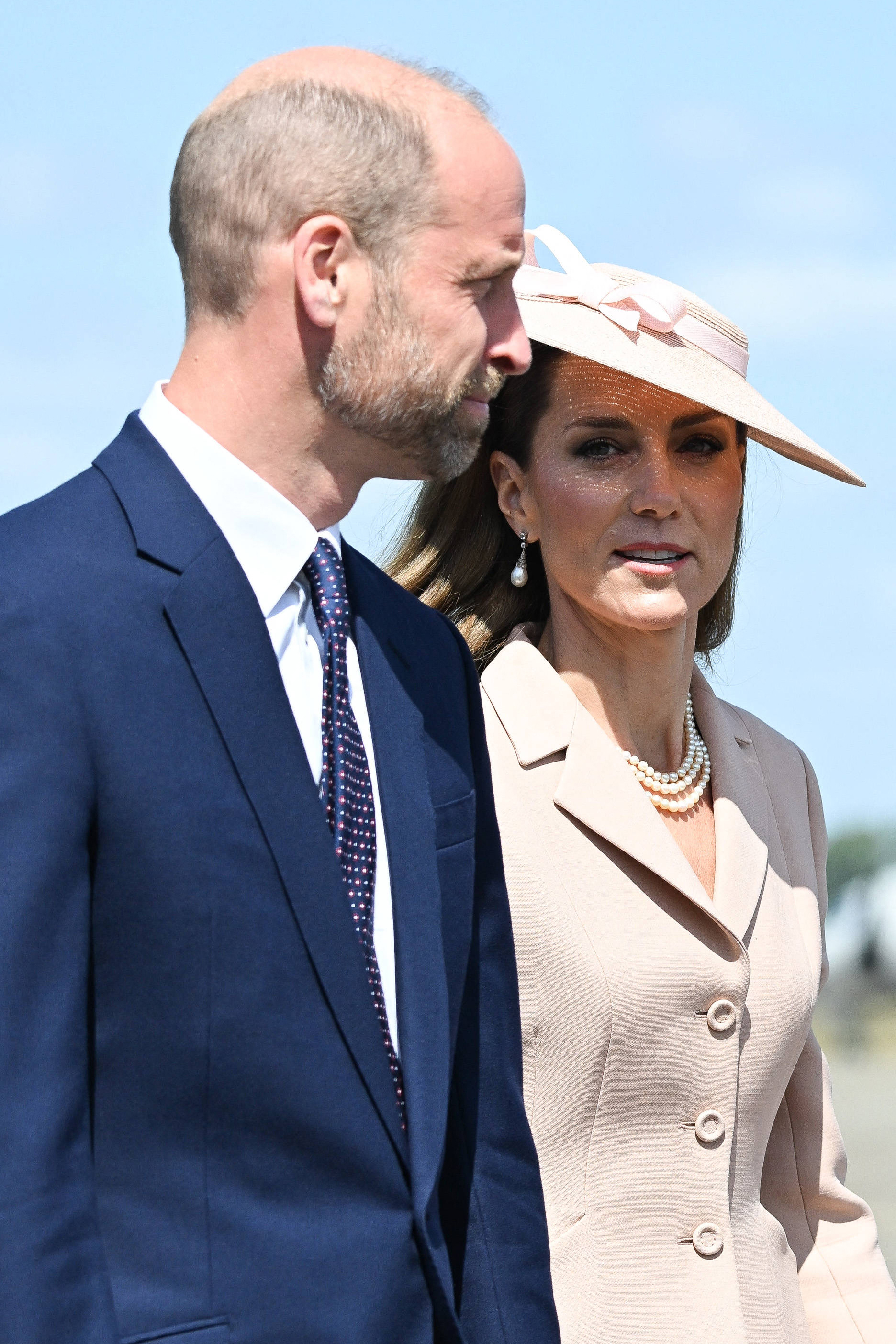 Princess Catherine looks directly at the camera while standing beside her husband, Prince William, at RAF Northolt.