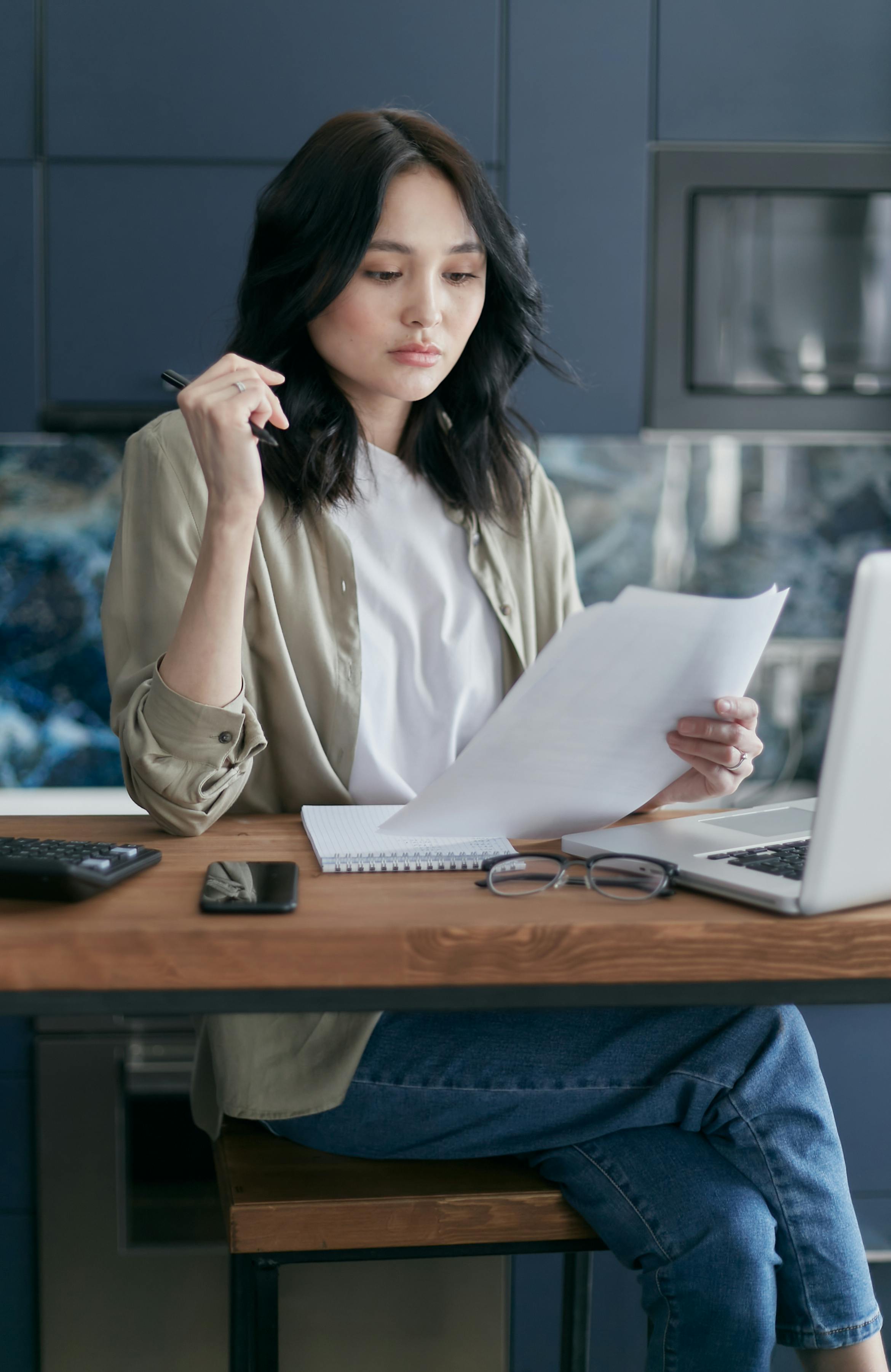 Woman signing documents | Source: Pexels