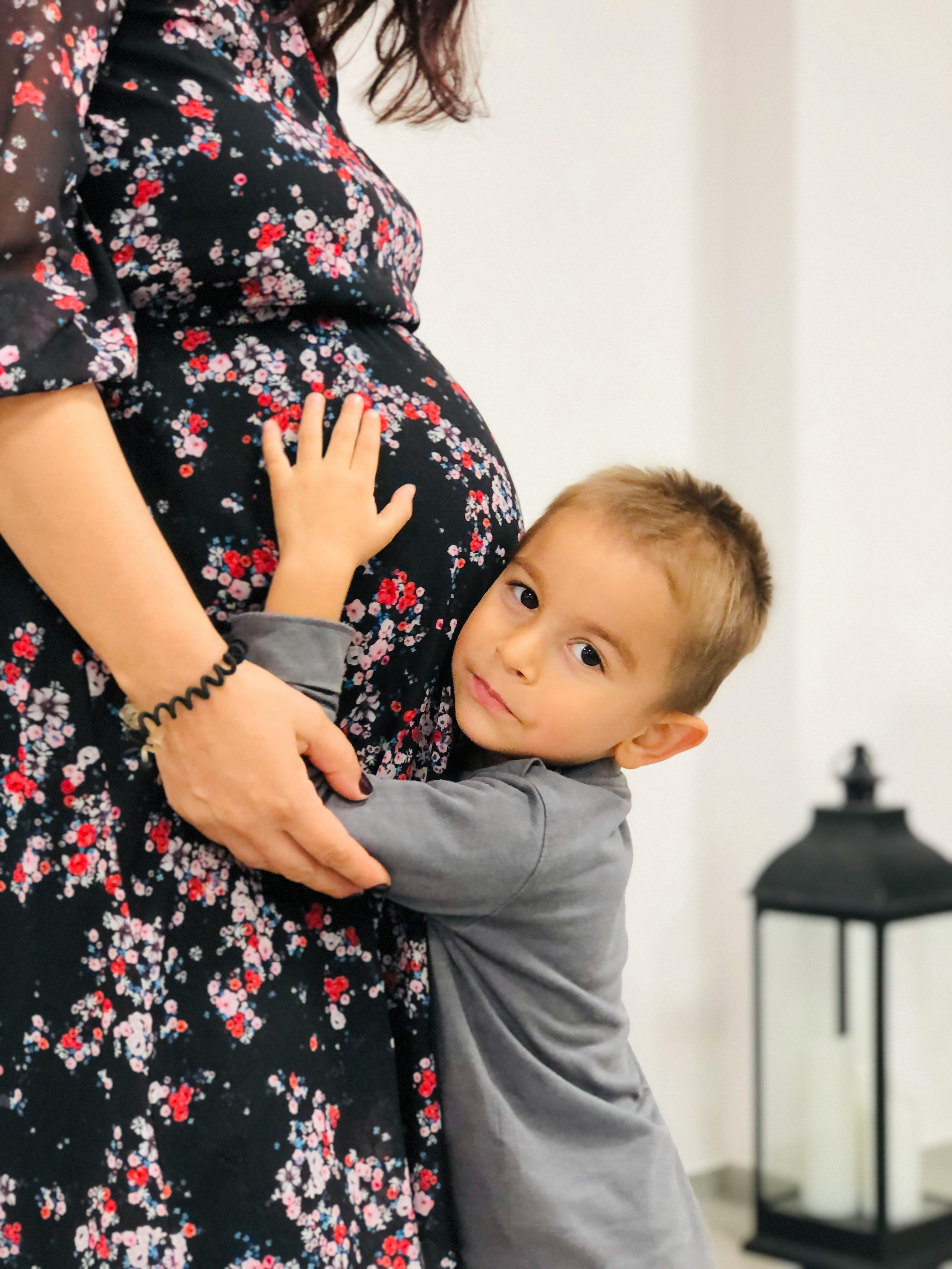 A child holding his pregnant mom | Source: Pexels