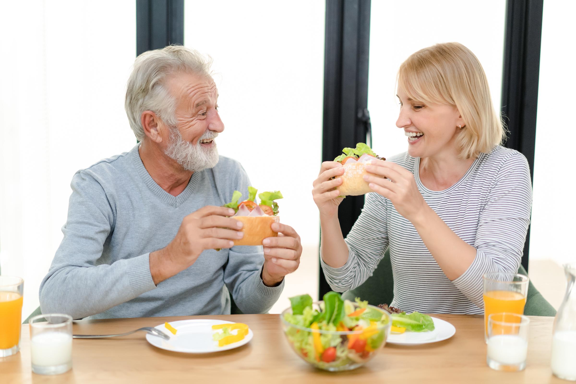 A senior couple enjoying a healthy meal | Source: Shutterstock