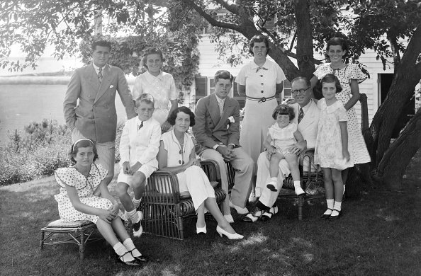 A portrait of the Kennedy family as they sit in the shade of some trees in Hyannis, Massachussetts, circa 1930. | Photo: Getty Images