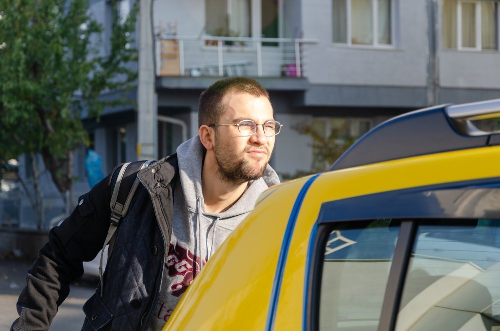 Irritated man getting into a cab. | Image: Shutterstock
