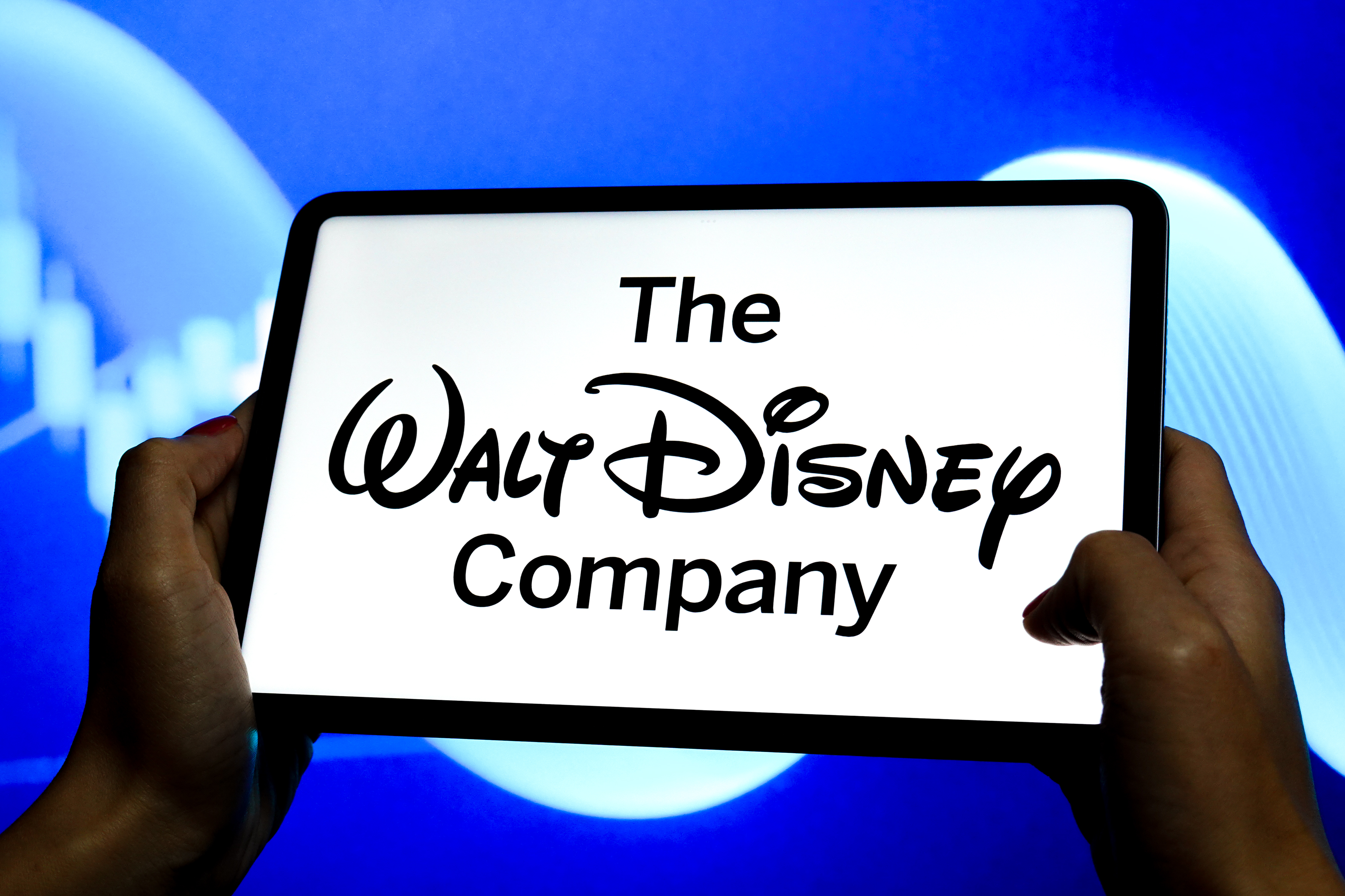 The logo of The Walt Disney Company is displayed on the screen of a tablet | Source: Getty Images