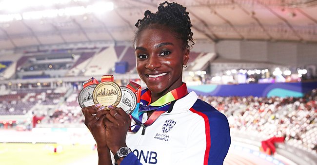 Dina Asher-Smith of Great Britain poses with her three championship medals during day ten of the 17th IAAF World Athletics Championships at Khalifa International Stadium on October 06, 2019 | Photo: Getty Images