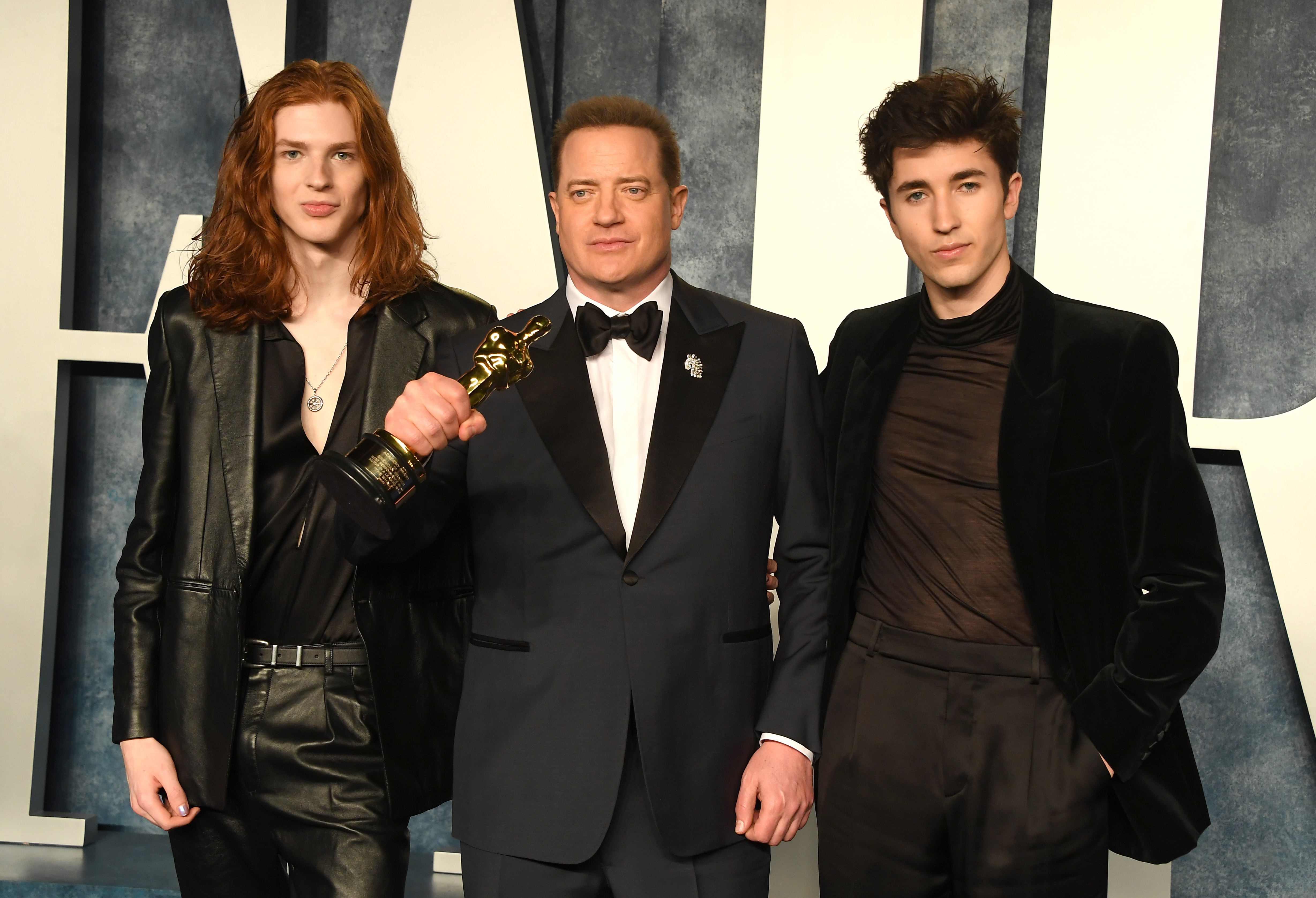 Leland Fraser, Brendan Fraser, and Griffin Fraser pose at the Vanity Fair Oscar Party hosted by Radhika Jones, with Brendan holding his Oscar.