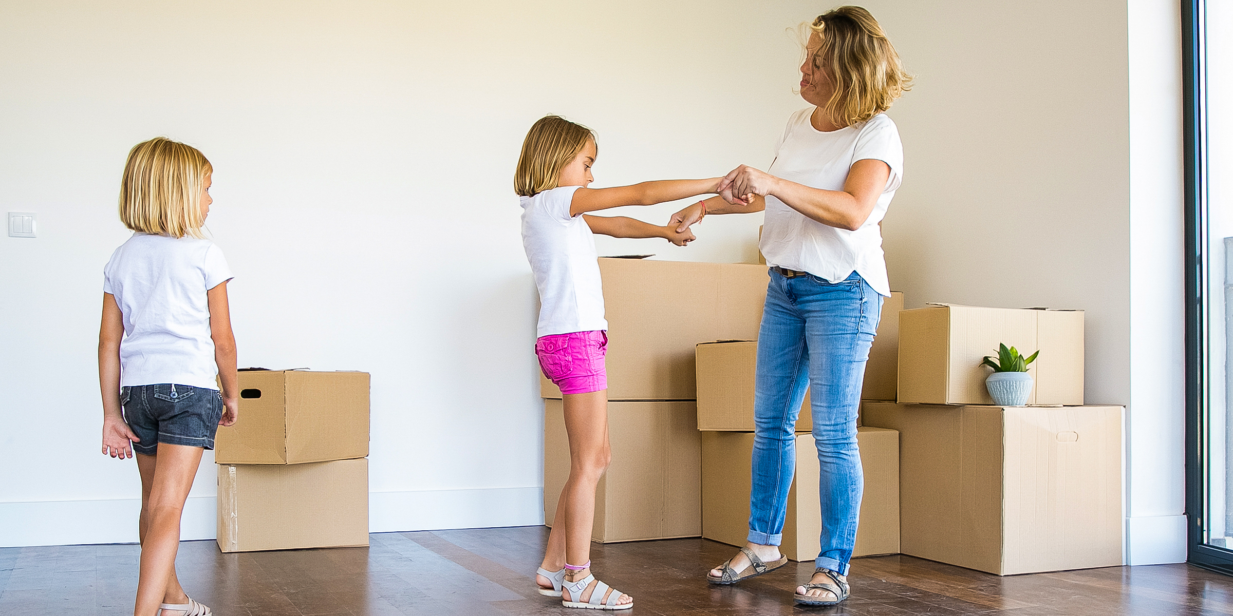 Mother and her children moving into a new home | Source: Shutterstock