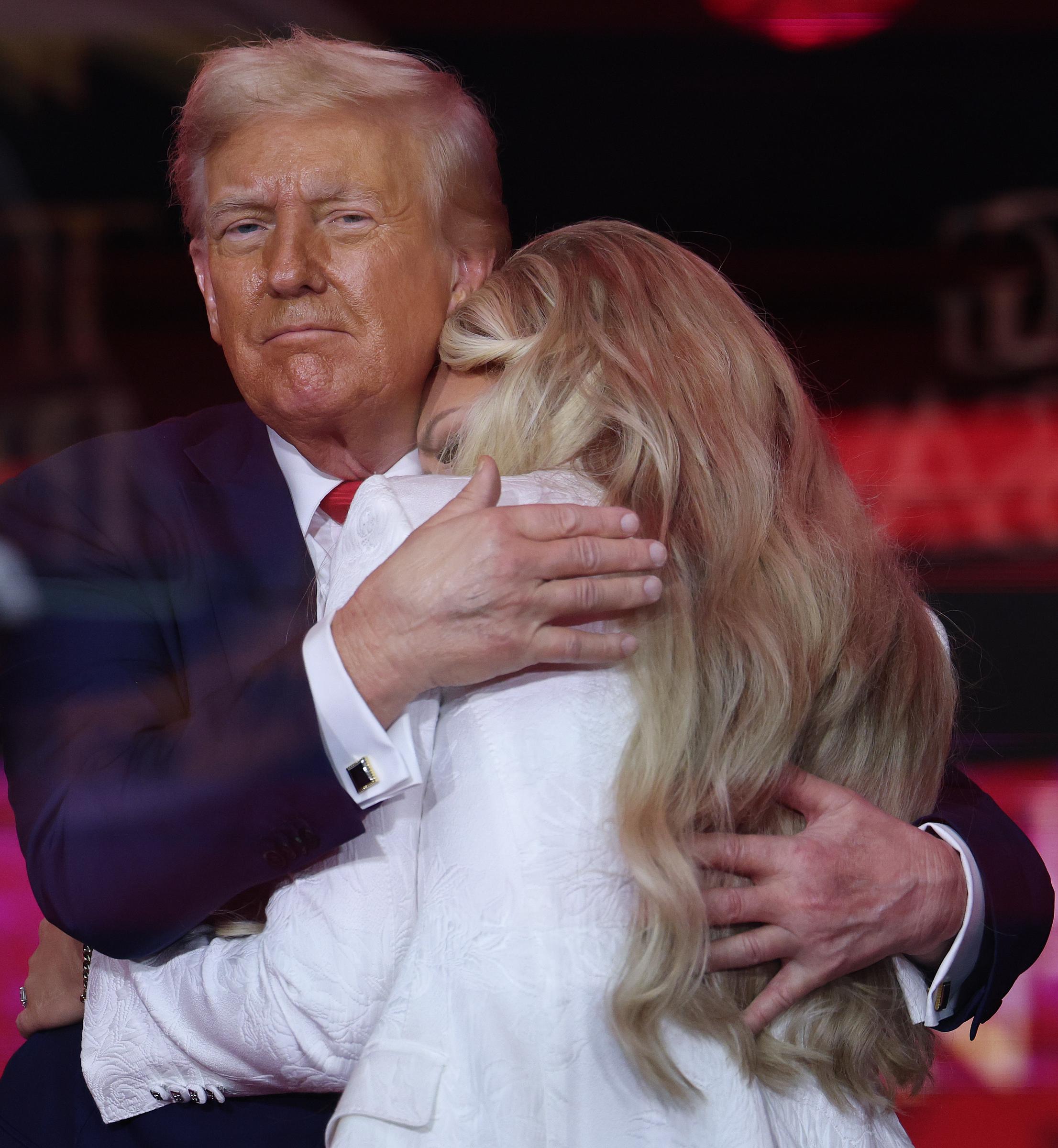 President Donald Trump embraces Erika Kirk onstage during the public memorial service for Charlie Kirk at State Farm Stadium on September 21, 2025 | Source: Getty Images