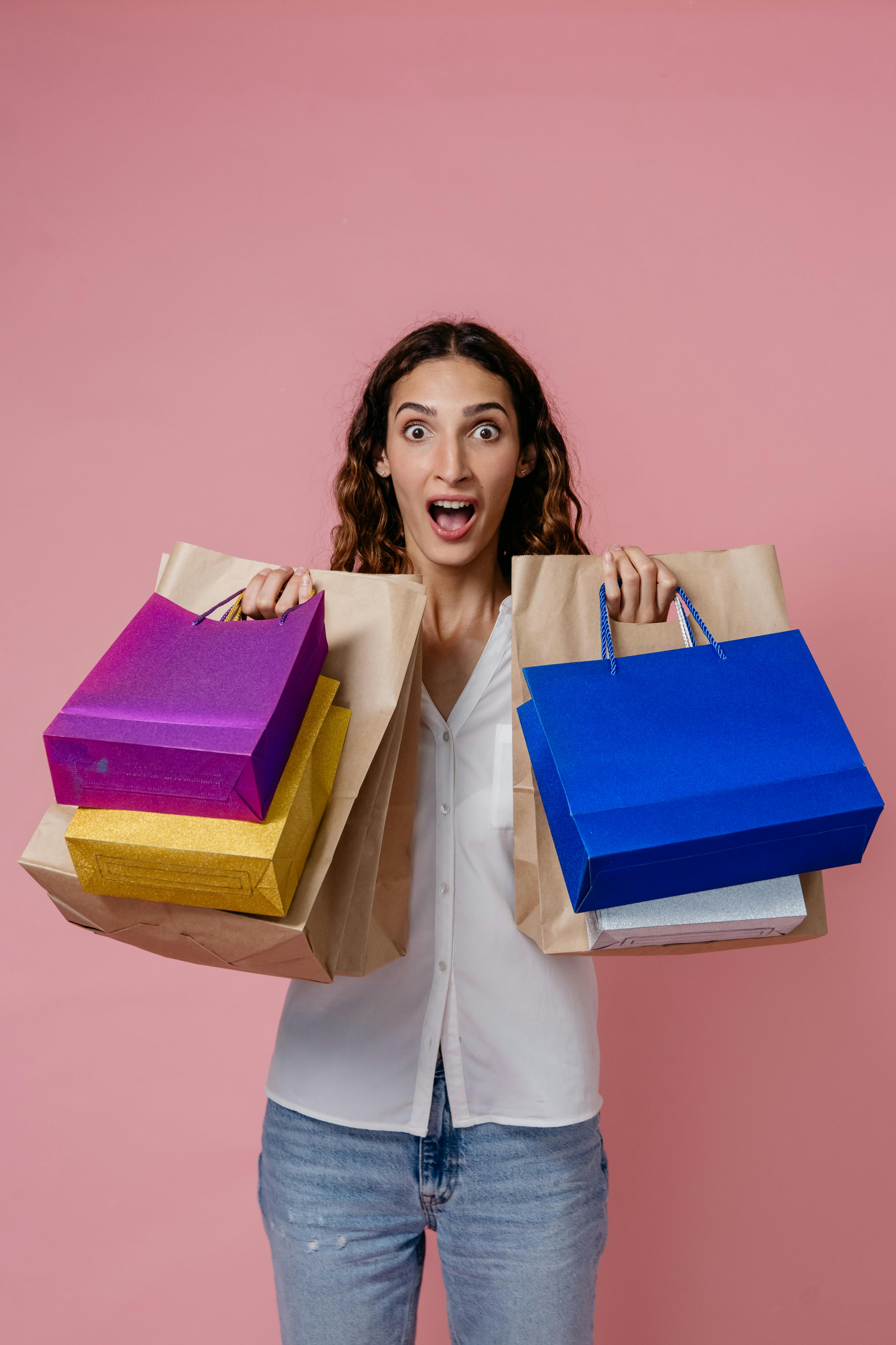 A shocked woman holding bags | Source: Pexels