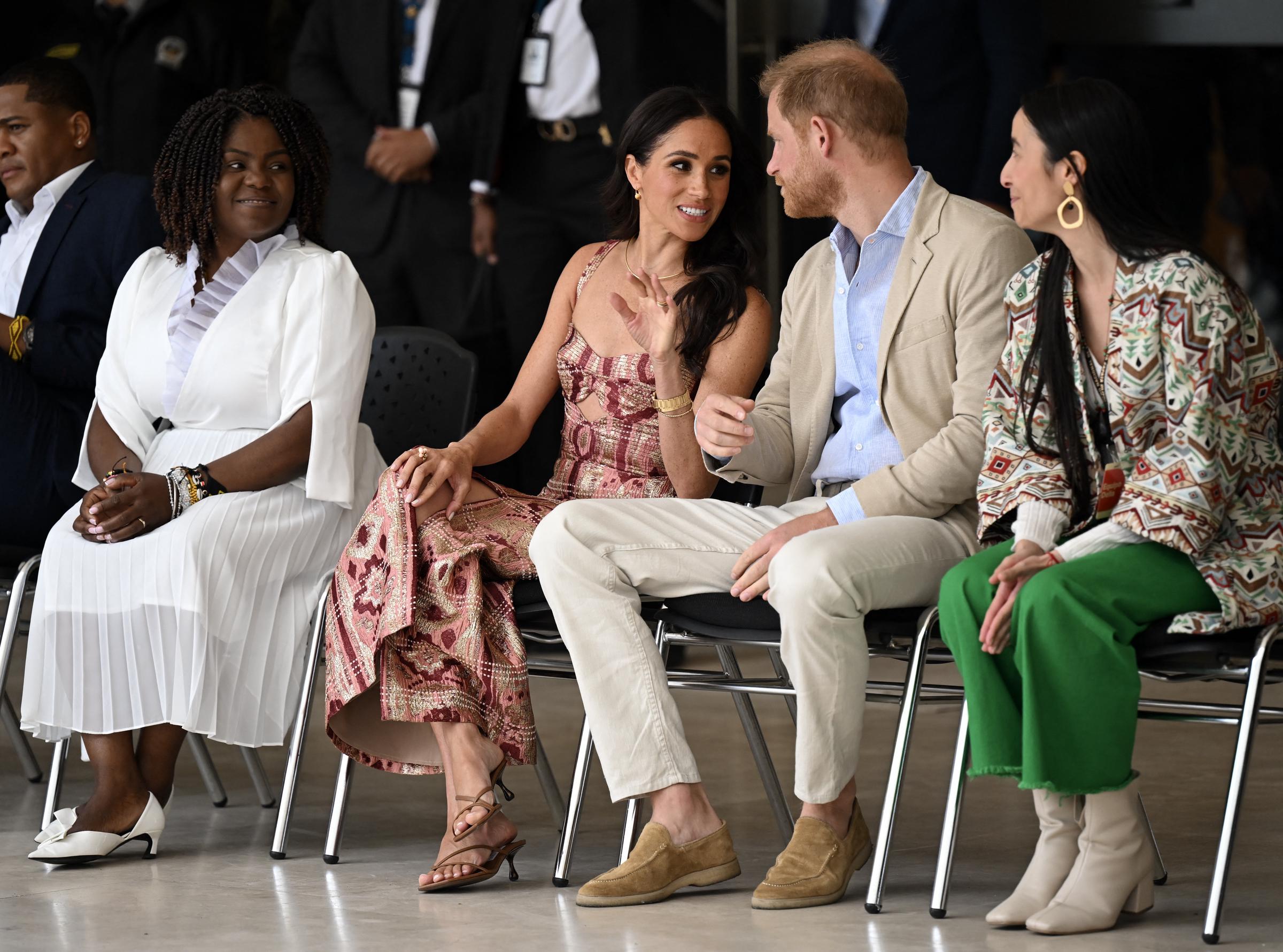 Meghan Markle and Prince Harry talk as they are seated beside Colombia's Vice President Francia Márquez, and National Centre for the Arts director, Xiomara Suescun in Bogotá on August 15, 2024 | Source: Getty Images