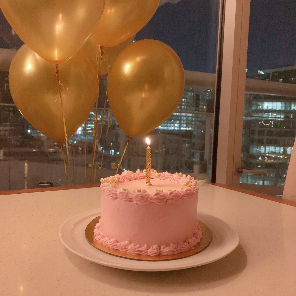 A pink birthday cake and gold balloons | Source: Midjourney