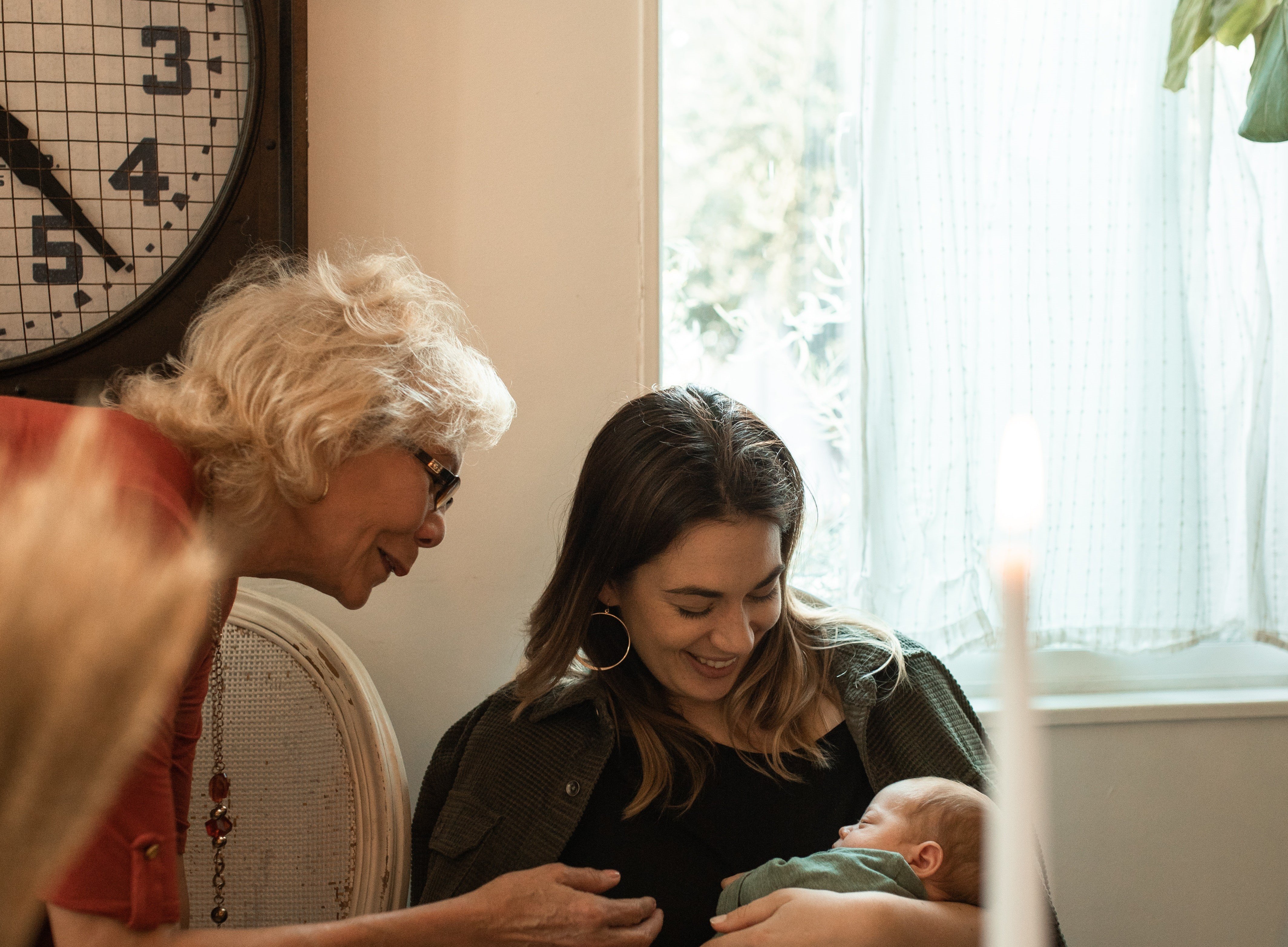 A mother holds her child as the mother-in-law looks. | Source: Pexels