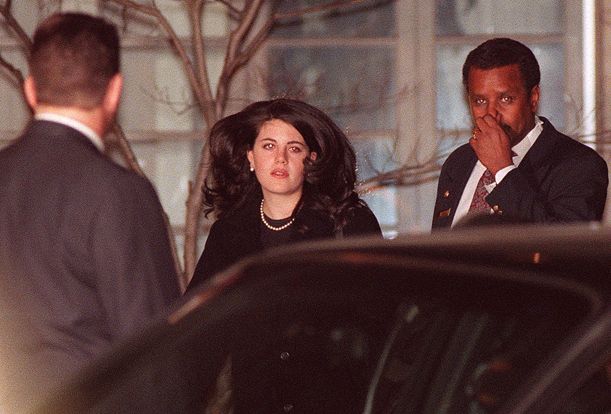 Monica Lewinsky (C) walks to a waiting car at the Cosmos Club on January 29, 1998 in Washington D.C. | Source: Getty Images