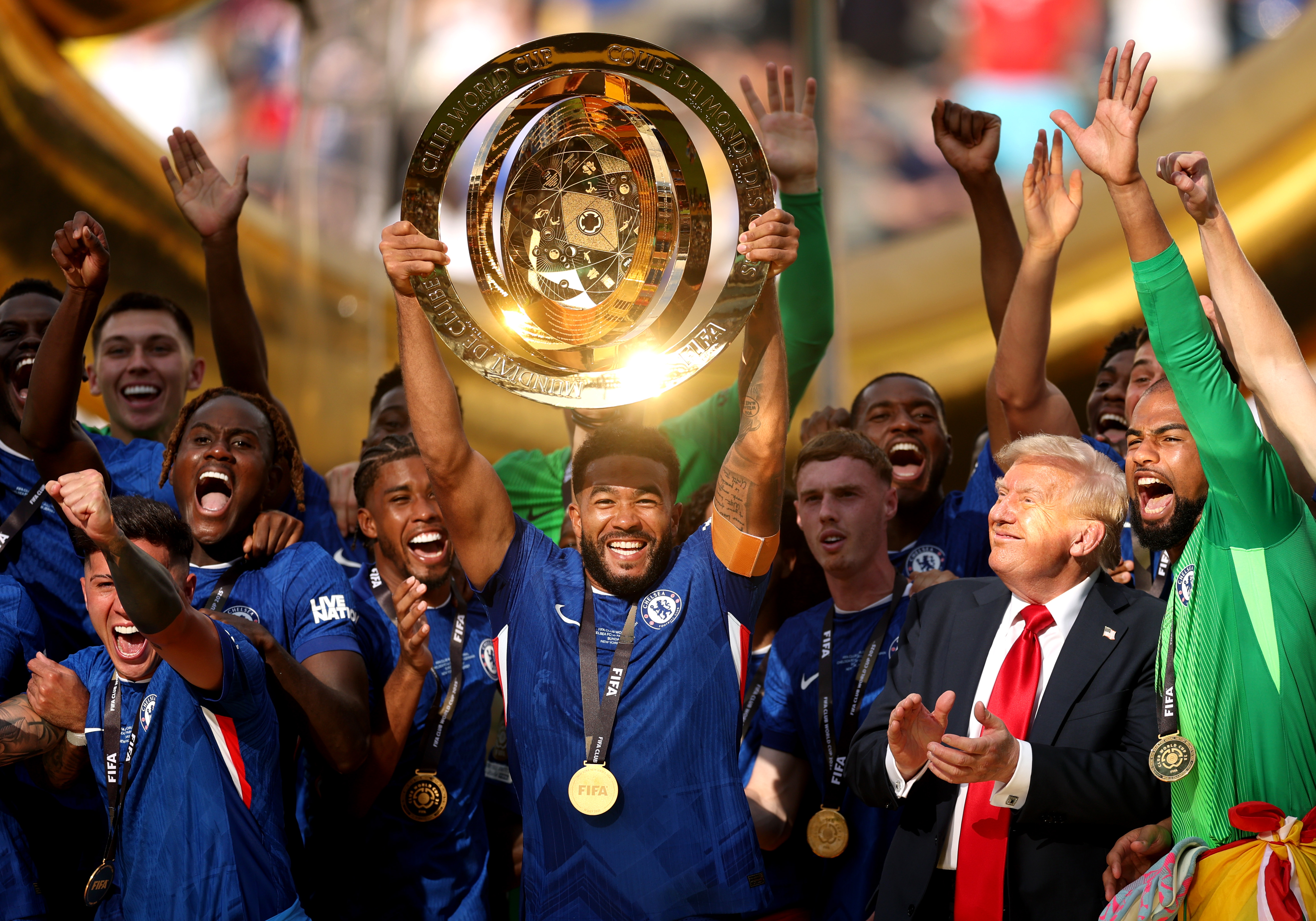 President Donald Trump while Reece James of Chelsea FC lifts the FIFA Club World Cup trophy at MetLife Stadium on July 13, 2025, in East Rutherford, New Jersey. | Source: Getty Images