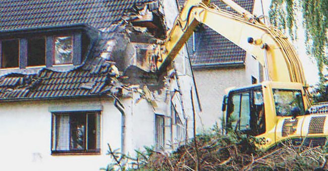 A machine demolishing a house | Source: Shutterstock