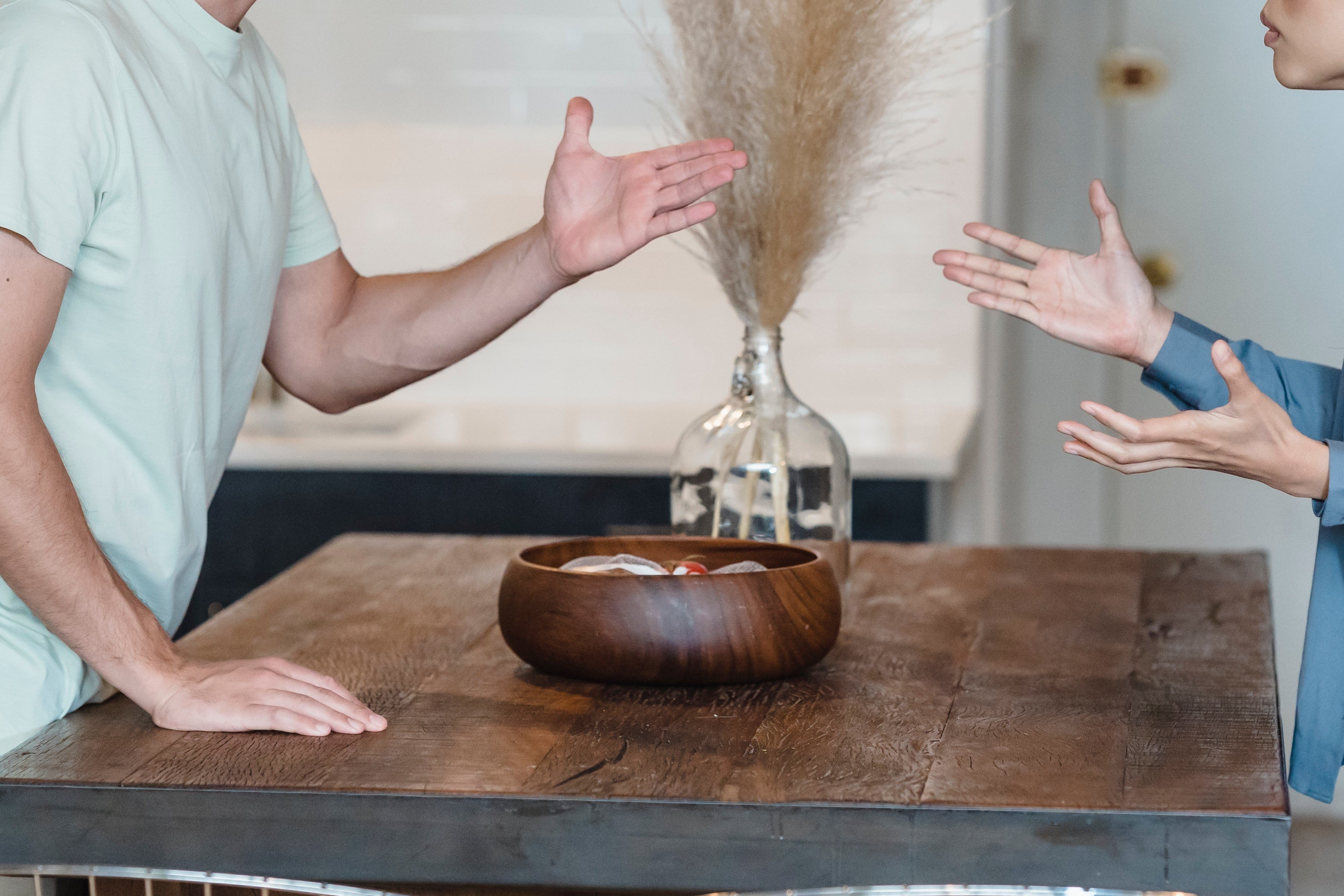 A man and woman gesturing with their hands while having a disagreement | Source: Pexels