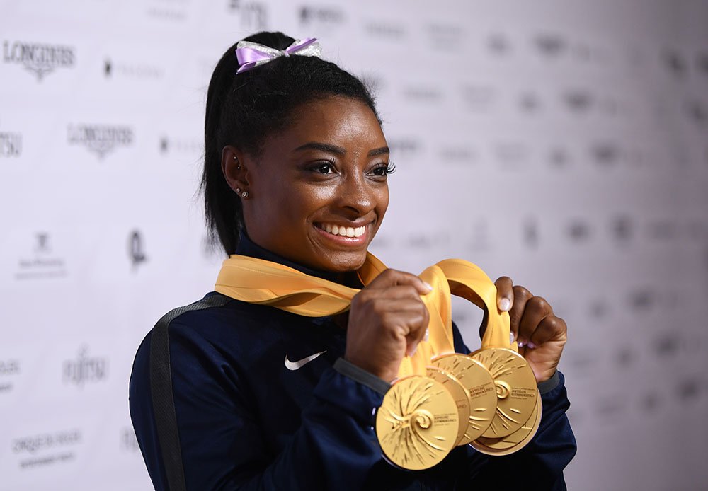 Simone Biles of The United States poses for photos with her multiple gold medals during day 10 of the 49th FIG Artistic Gymnastics World Championships at Hanns-Martin-Schleyer-Halle on October 13, 2019 in Stuttgart, Germany. I Image: Getty Images./GlobalImagesUkraine