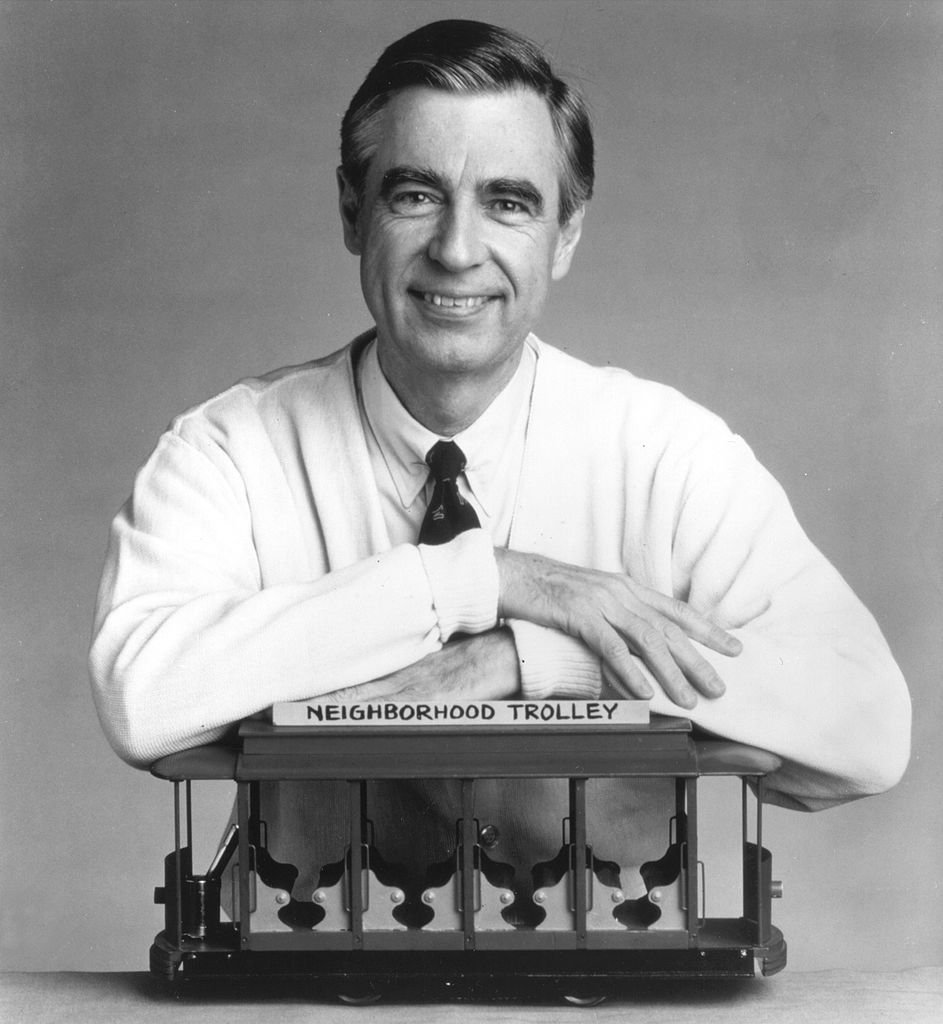 Fred Rogers, The Host Of The Children's Television Series, "Mr. Rogers' Neighborhood," Rests His Arms On A Small Trolley In This Promotional Portrait From The 1980's. | Photo: Getty Images