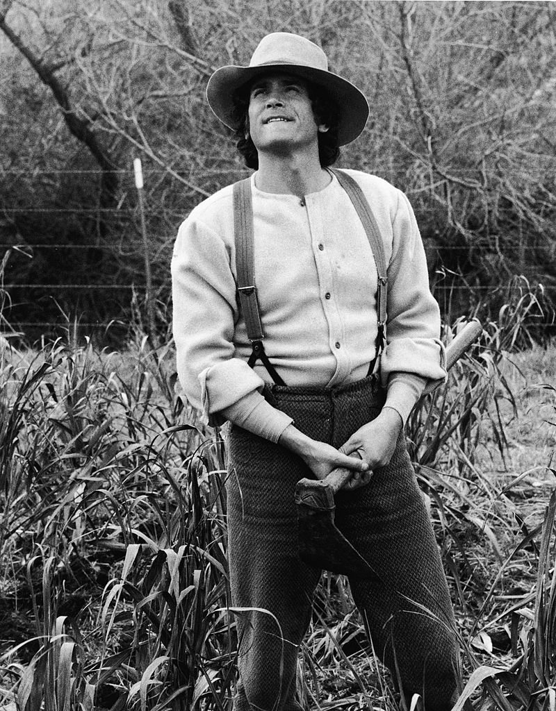 Michael Landon stands in a field in a still from the television series, "The Little House On The Prairie." | Photo: Getty Images