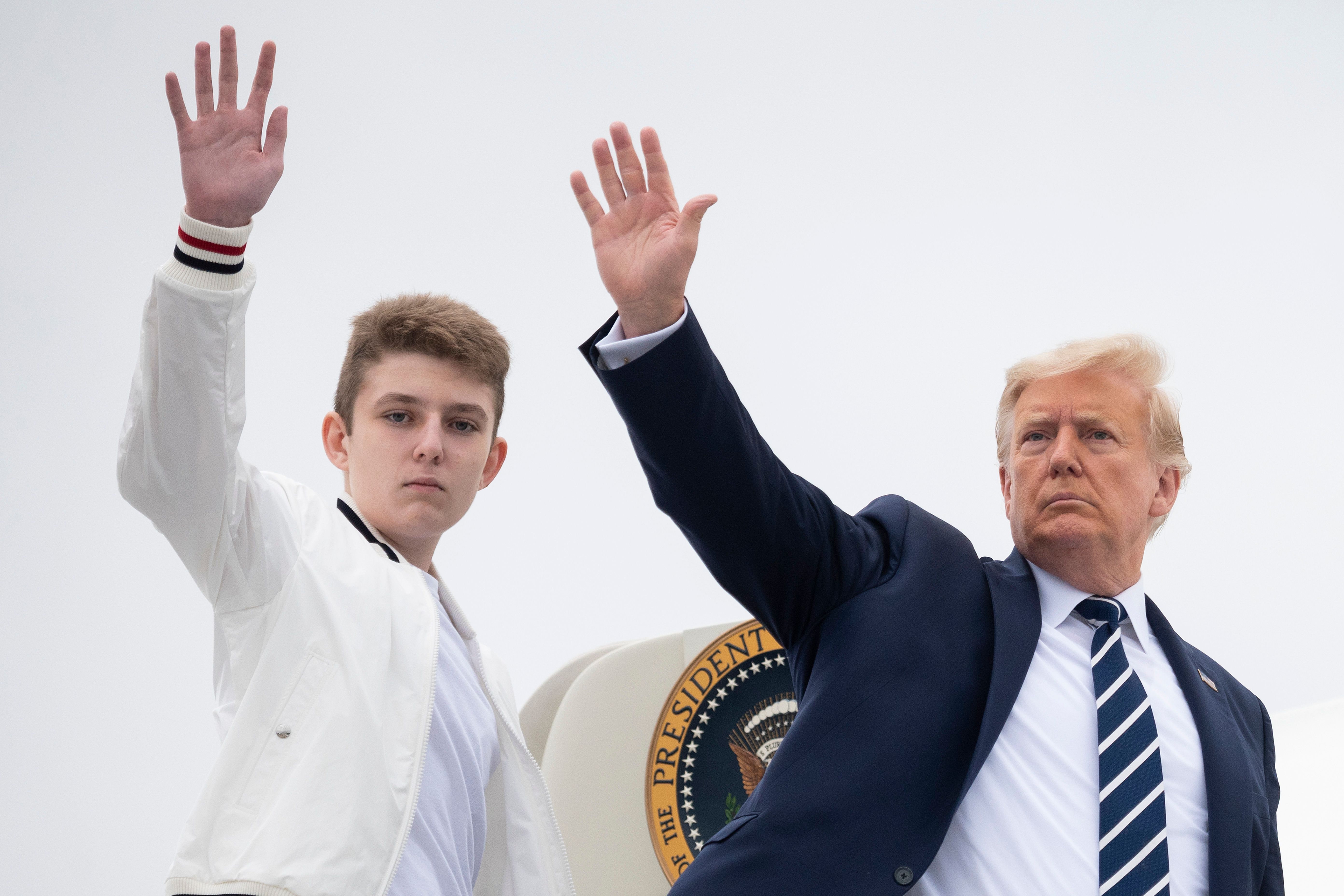 U.S. President Donald Trump and Barron wave as they board Air Force One at Morristown Municipal Airport in Morristown, New Jersey, on August 16, 2020. | Source: Getty Images